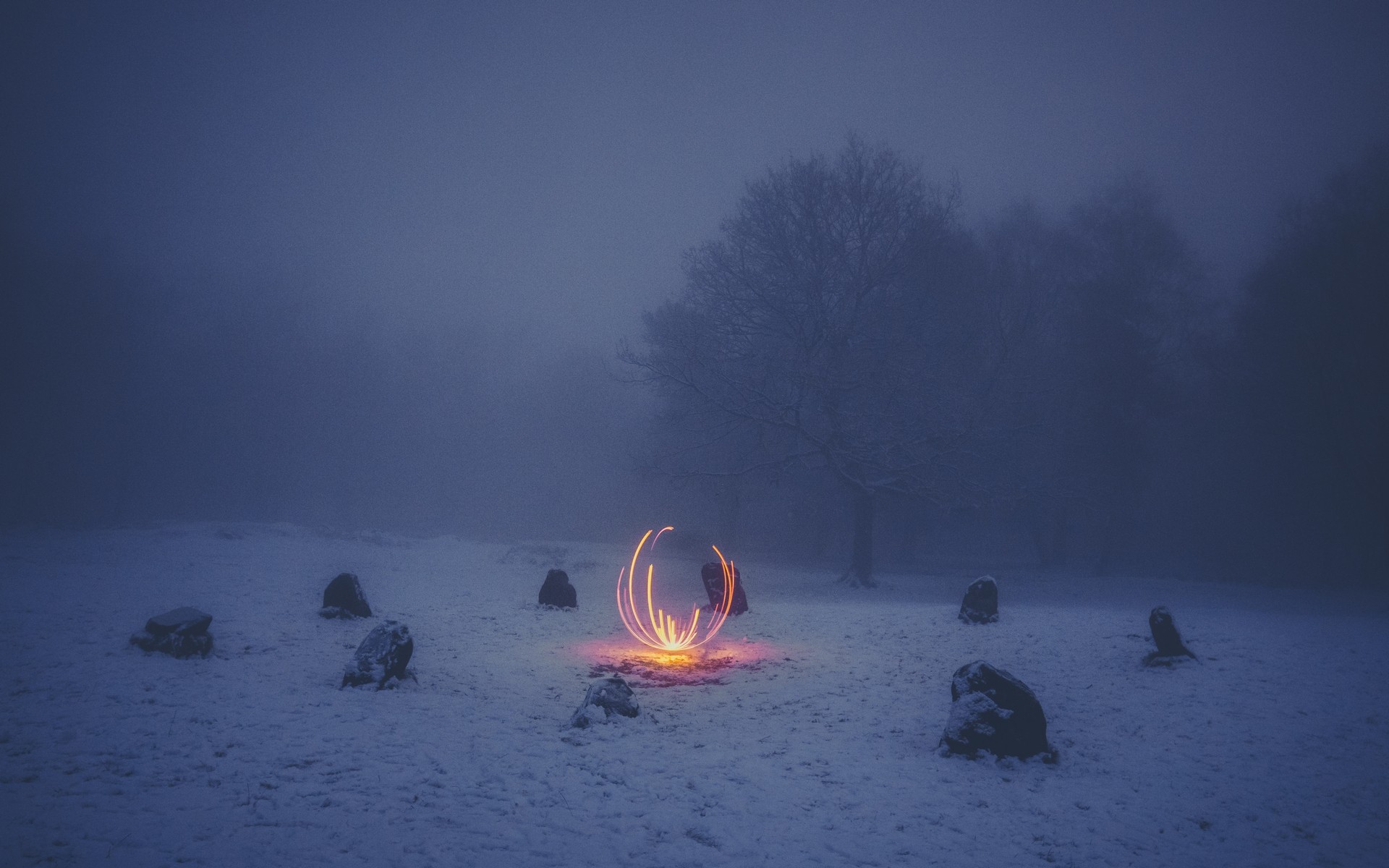 Winter scene with glowing orb and standing stones HD Wallpaper