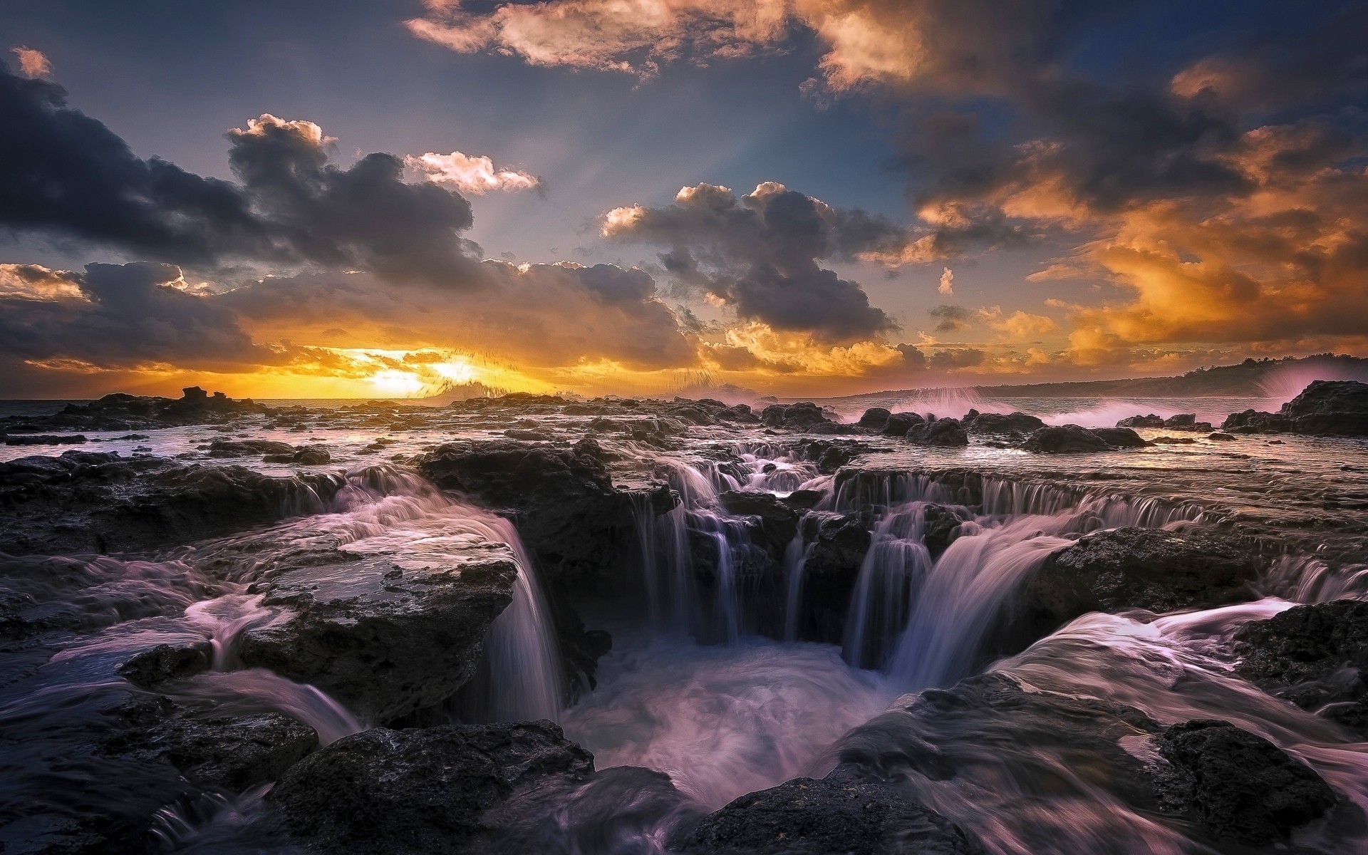Rocky coastline with waterfalls at sunset HD Wallpaper