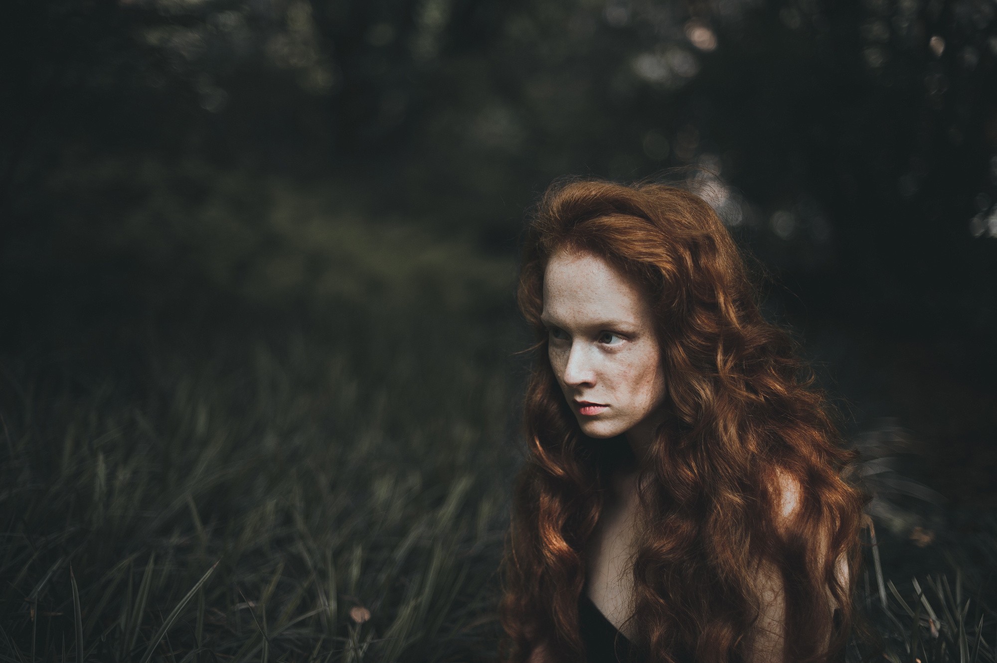 Redhead woman with curly hair in grass HD Wallpaper
