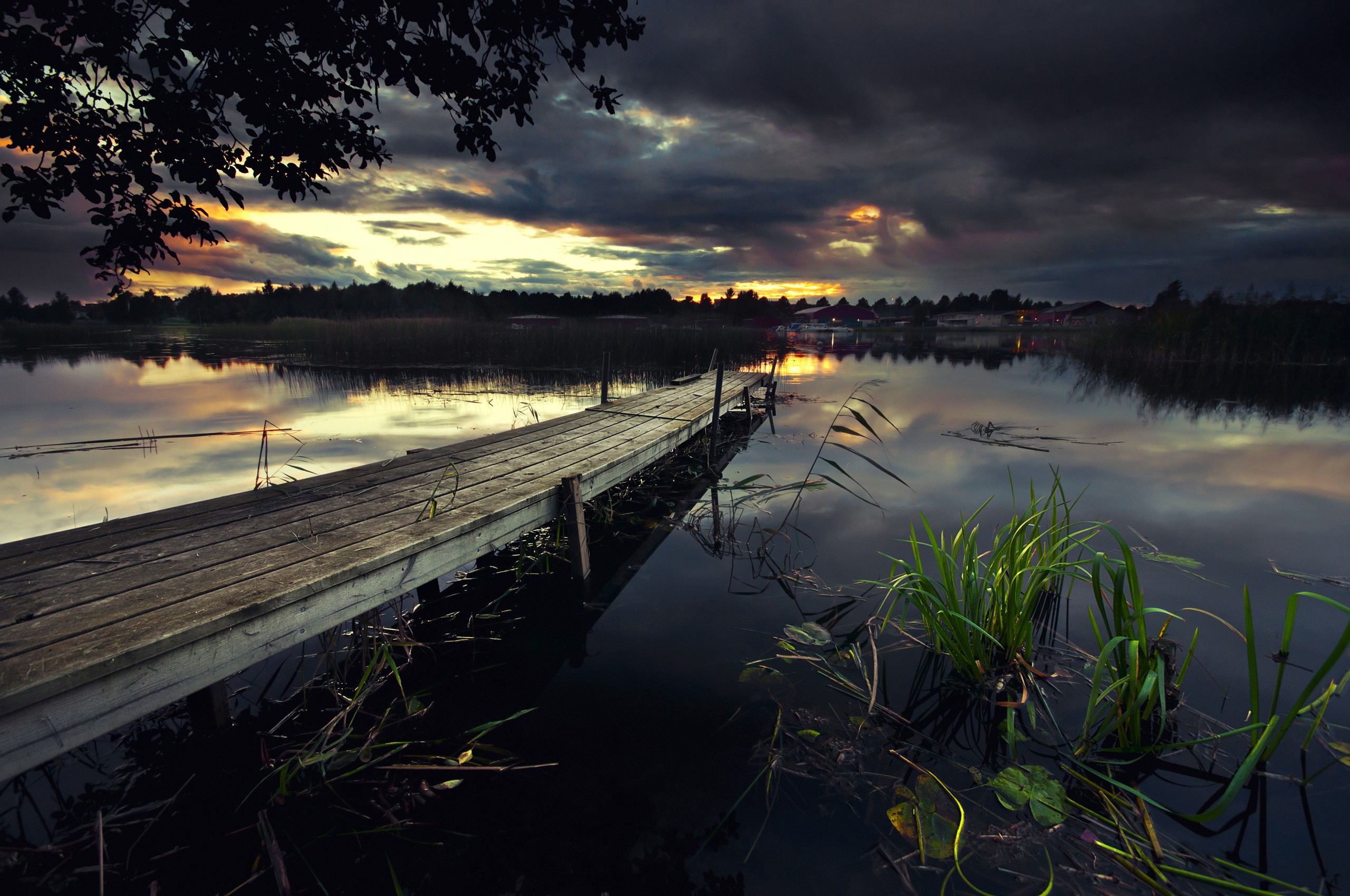 Wooden pier on a lake at sunset with dramatic clouds HD Wallpaper
