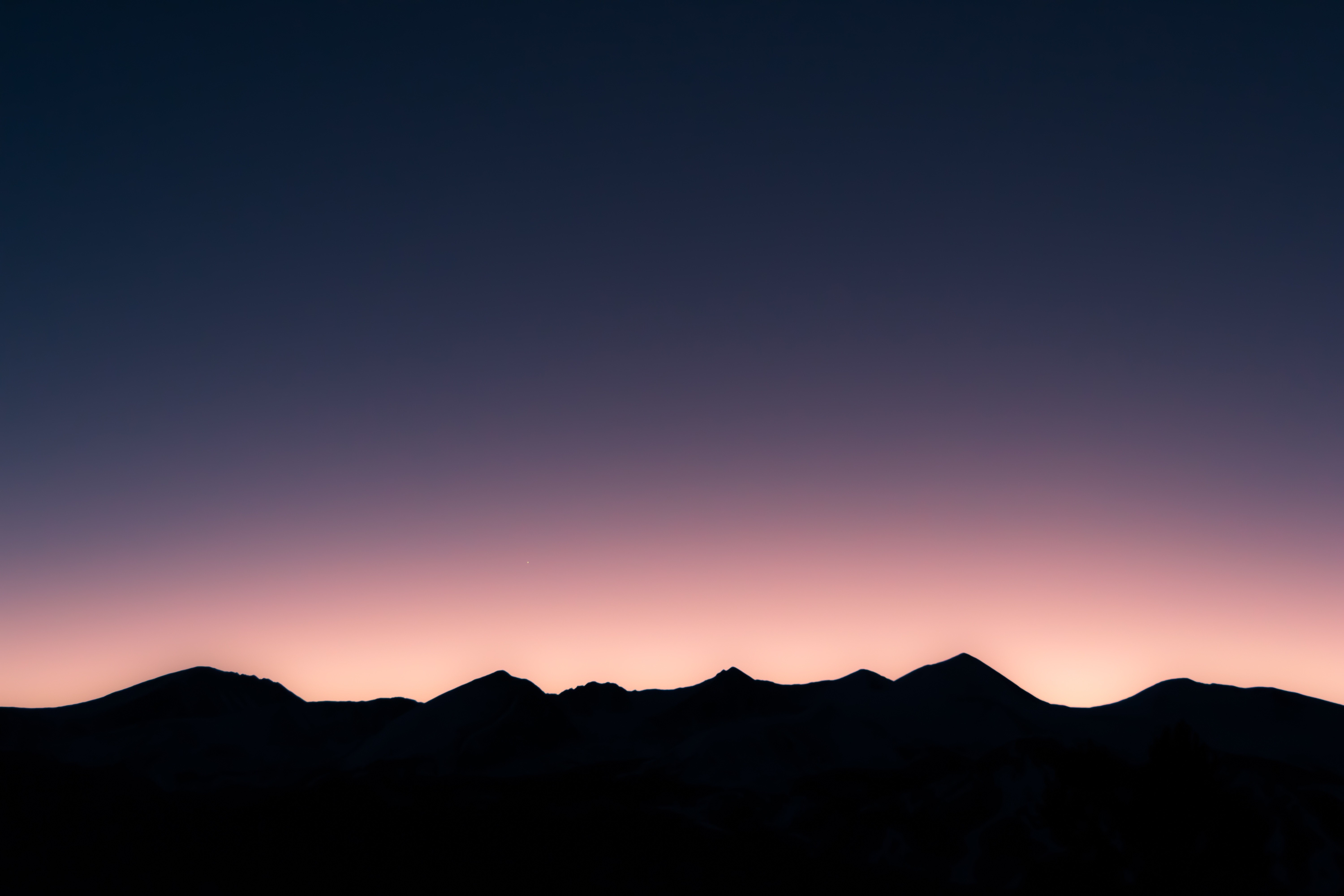 Silhouette of mountains against a twilight sky HD Wallpaper