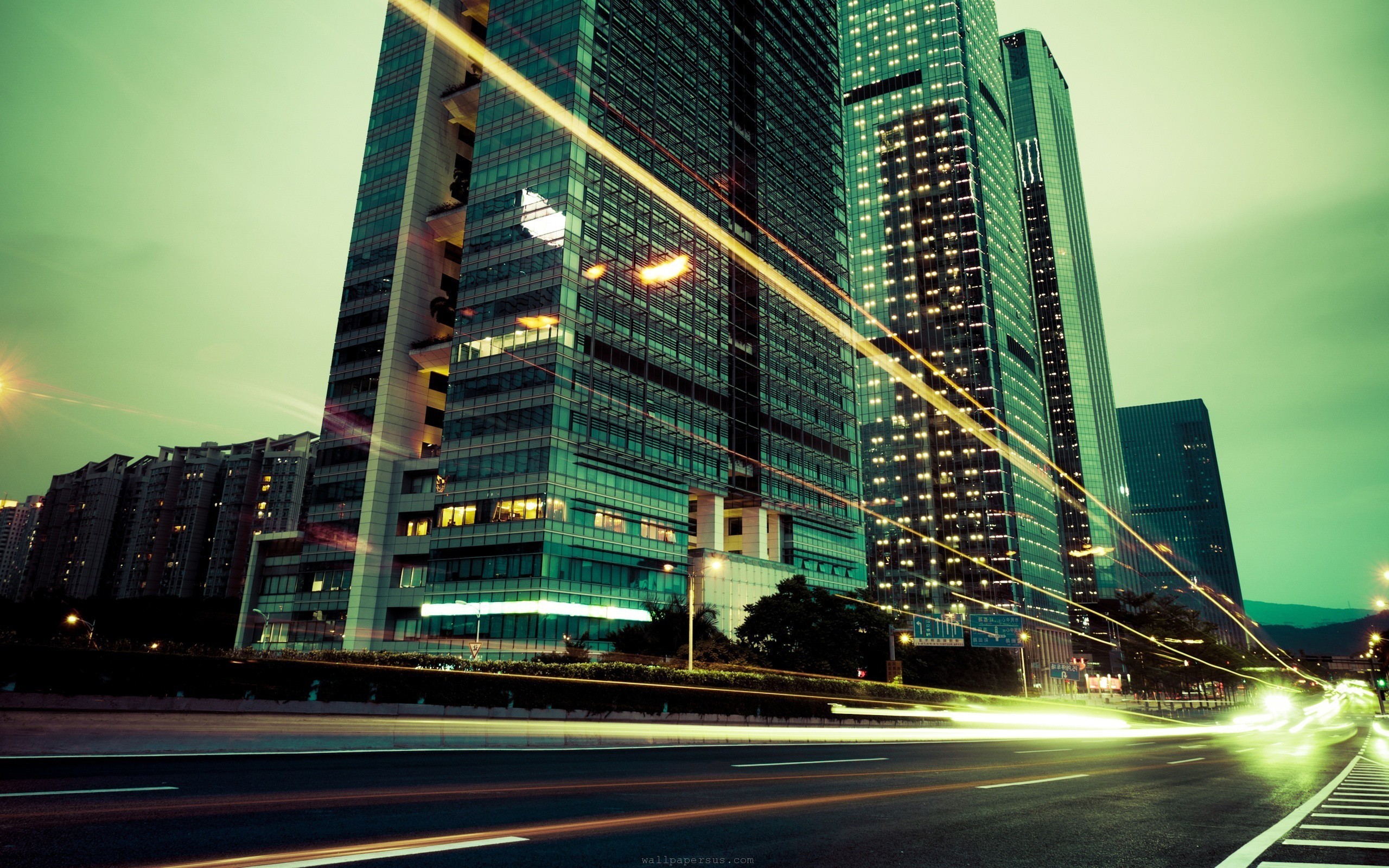 Long exposure photography of a city highway with skyscrapers HD Wallpaper