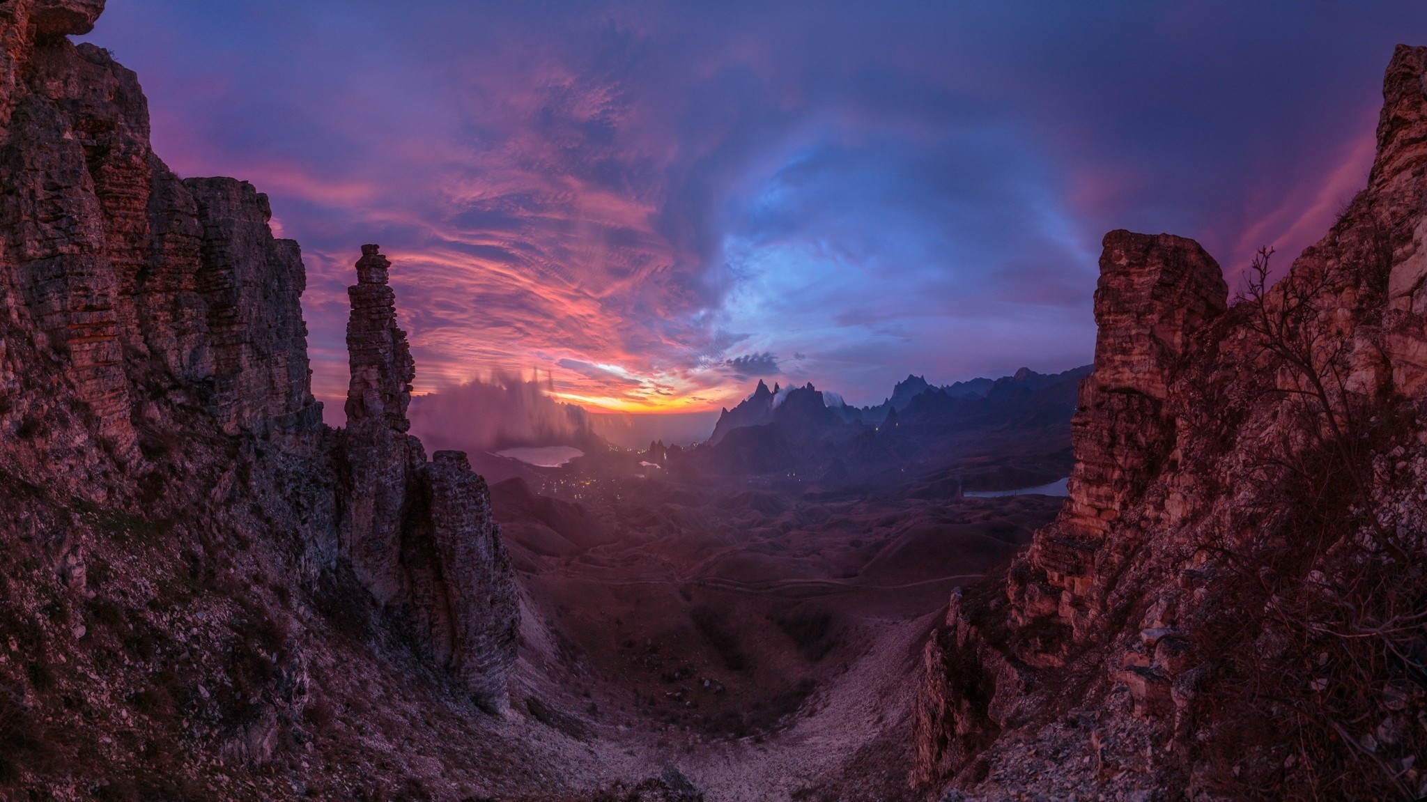 Sunset over a rocky valley with dramatic clouds HD Wallpaper