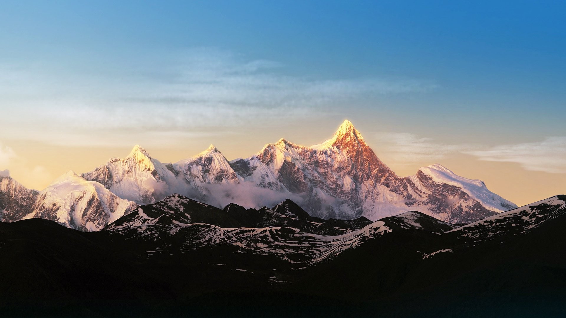 Snow-capped mountains at sunrise HD Wallpaper