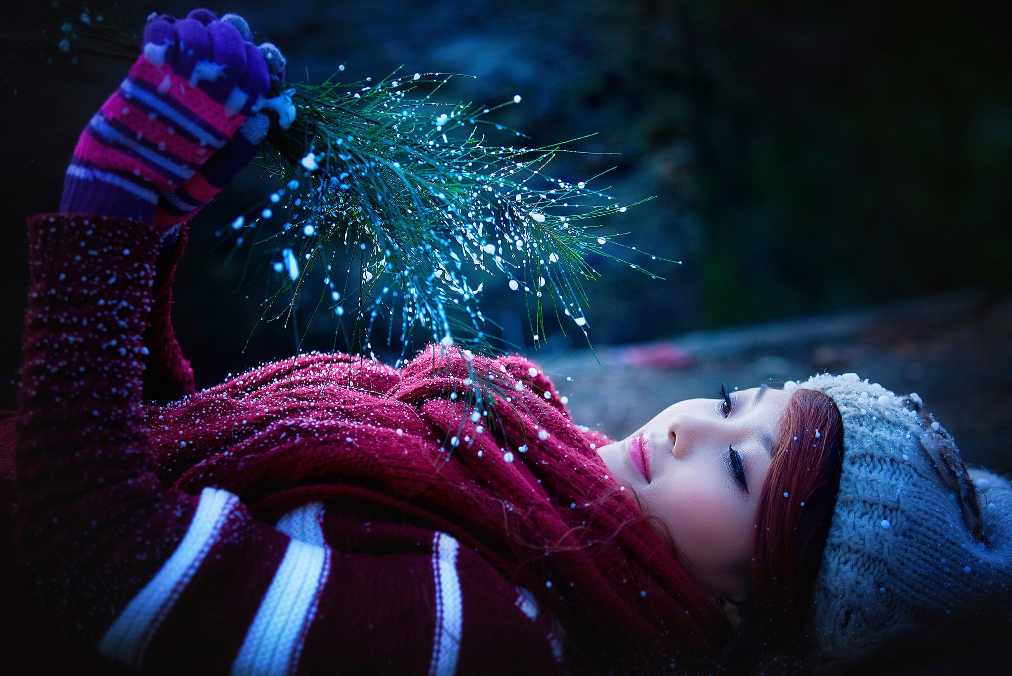 Asian woman in winter attire with pine branch HD Wallpaper