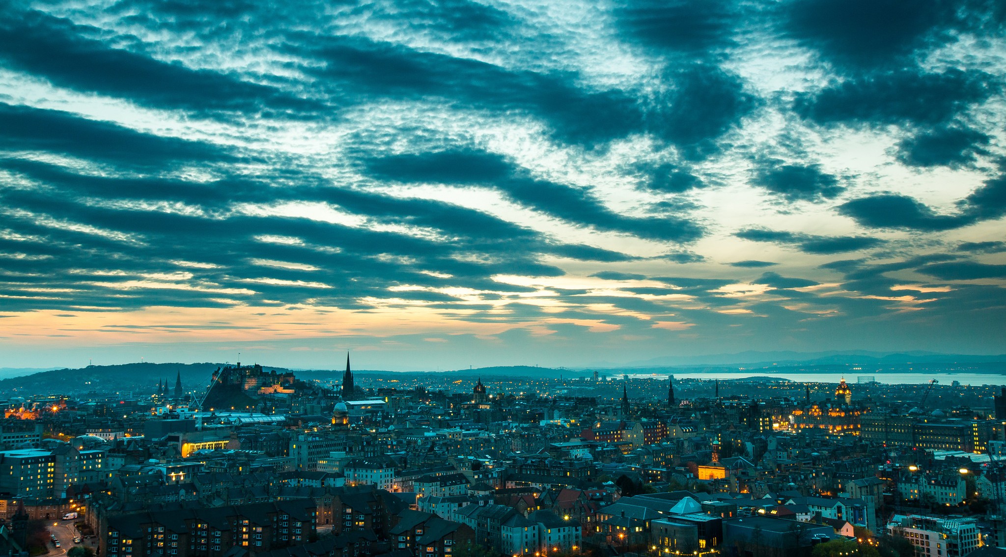 Edinburgh cityscape with dramatic clouds at dusk HD Wallpaper