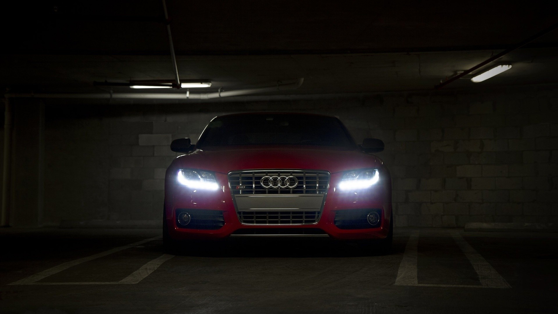 Red Audi car parked in a dark garage HD Wallpaper