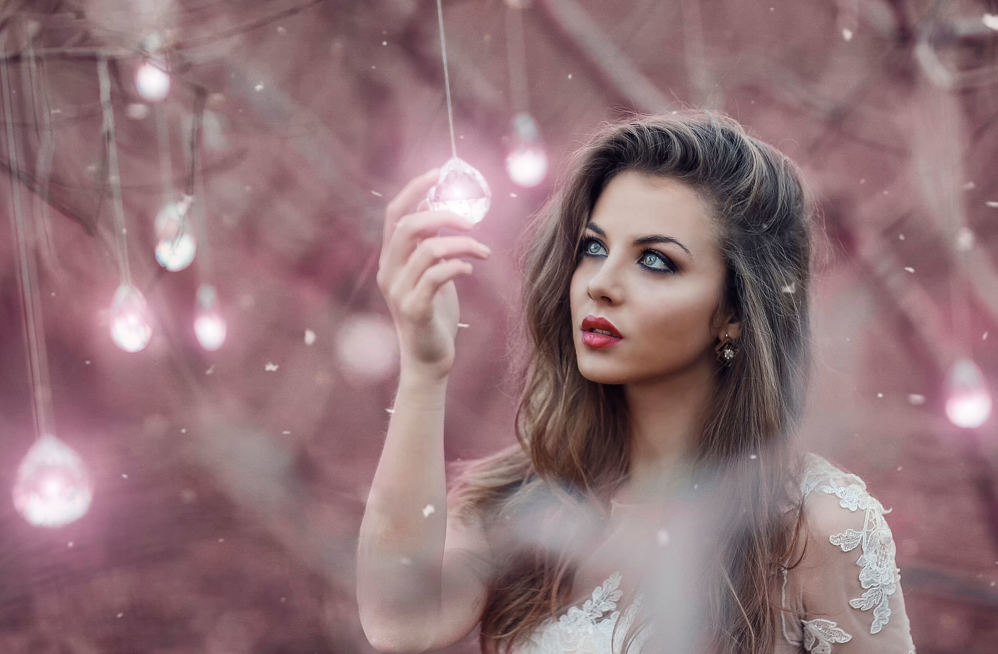 Woman holding a glowing orb with lights in background HD Wallpaper