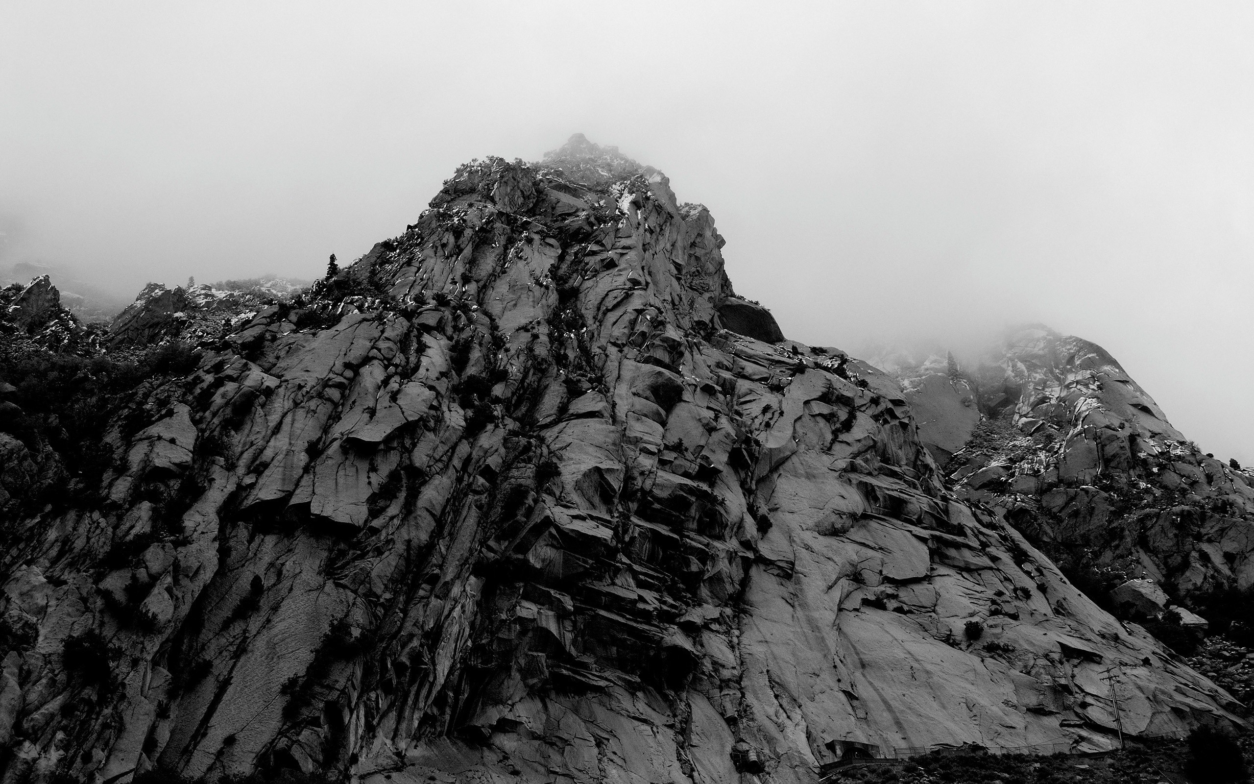 Jagged mountain peak shrouded in mist HD Wallpaper
