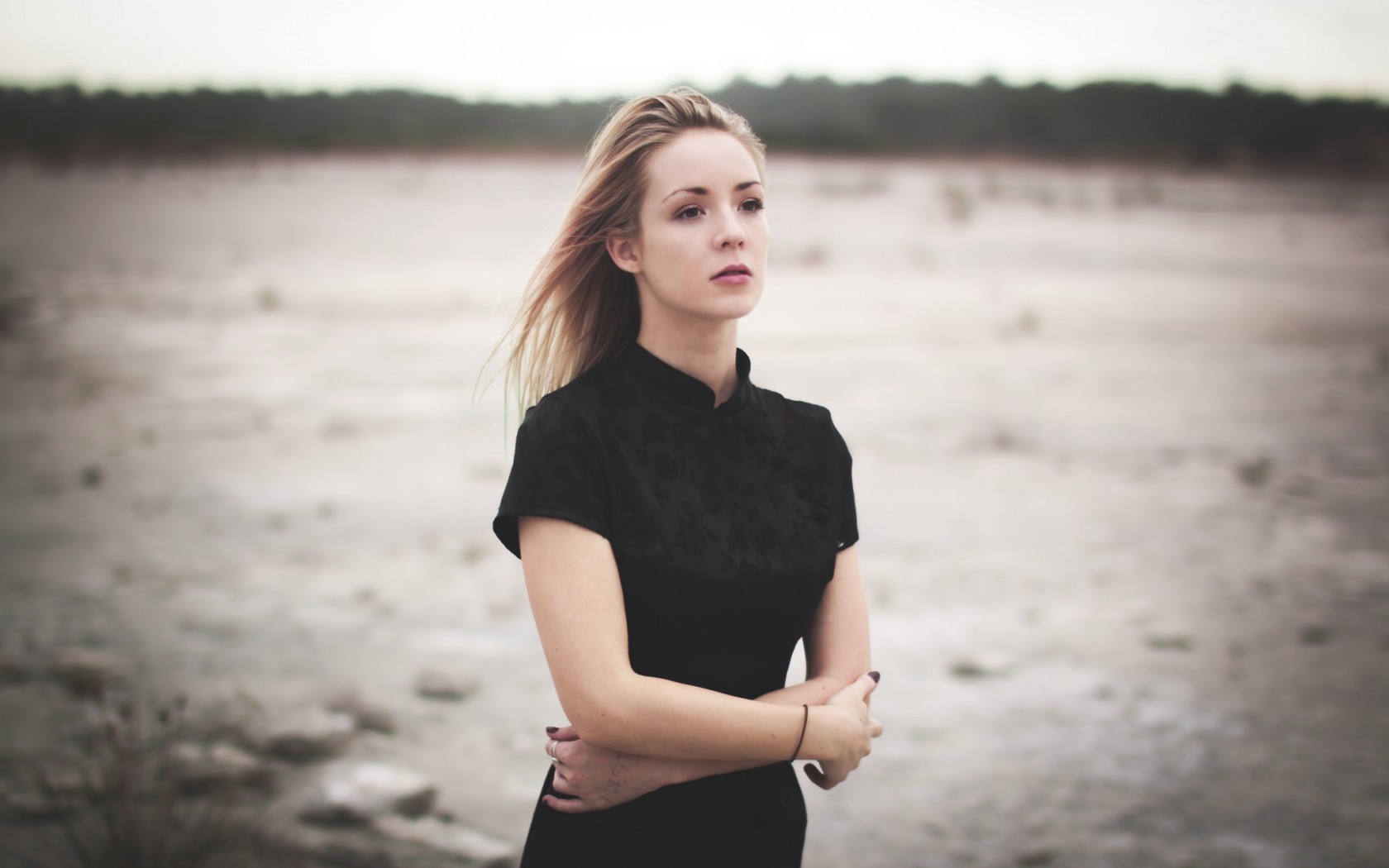 Woman in black dress standing outdoors HD Wallpaper