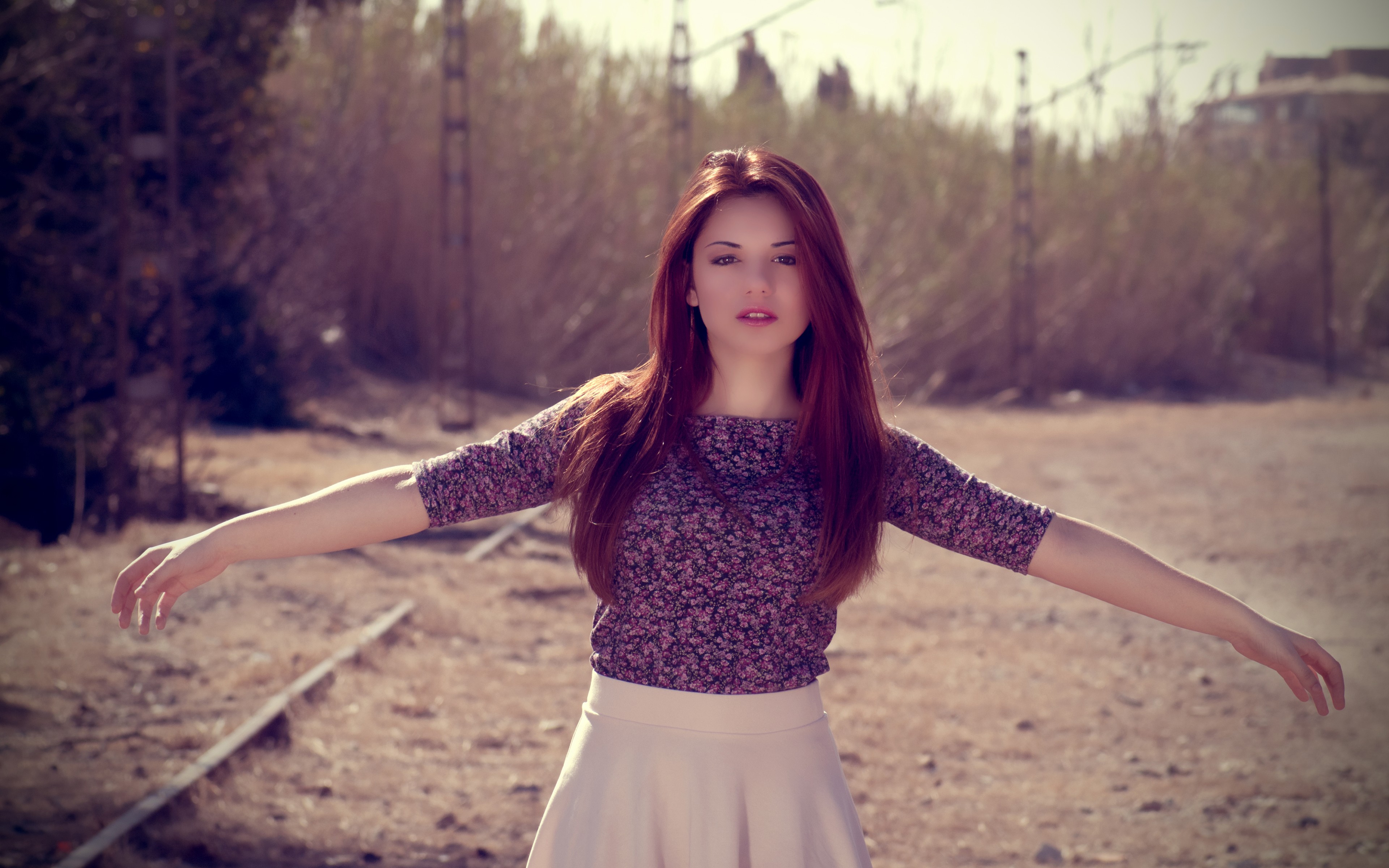 Delaia Gonzalez posing outdoors with arms outstretched HD Wallpaper