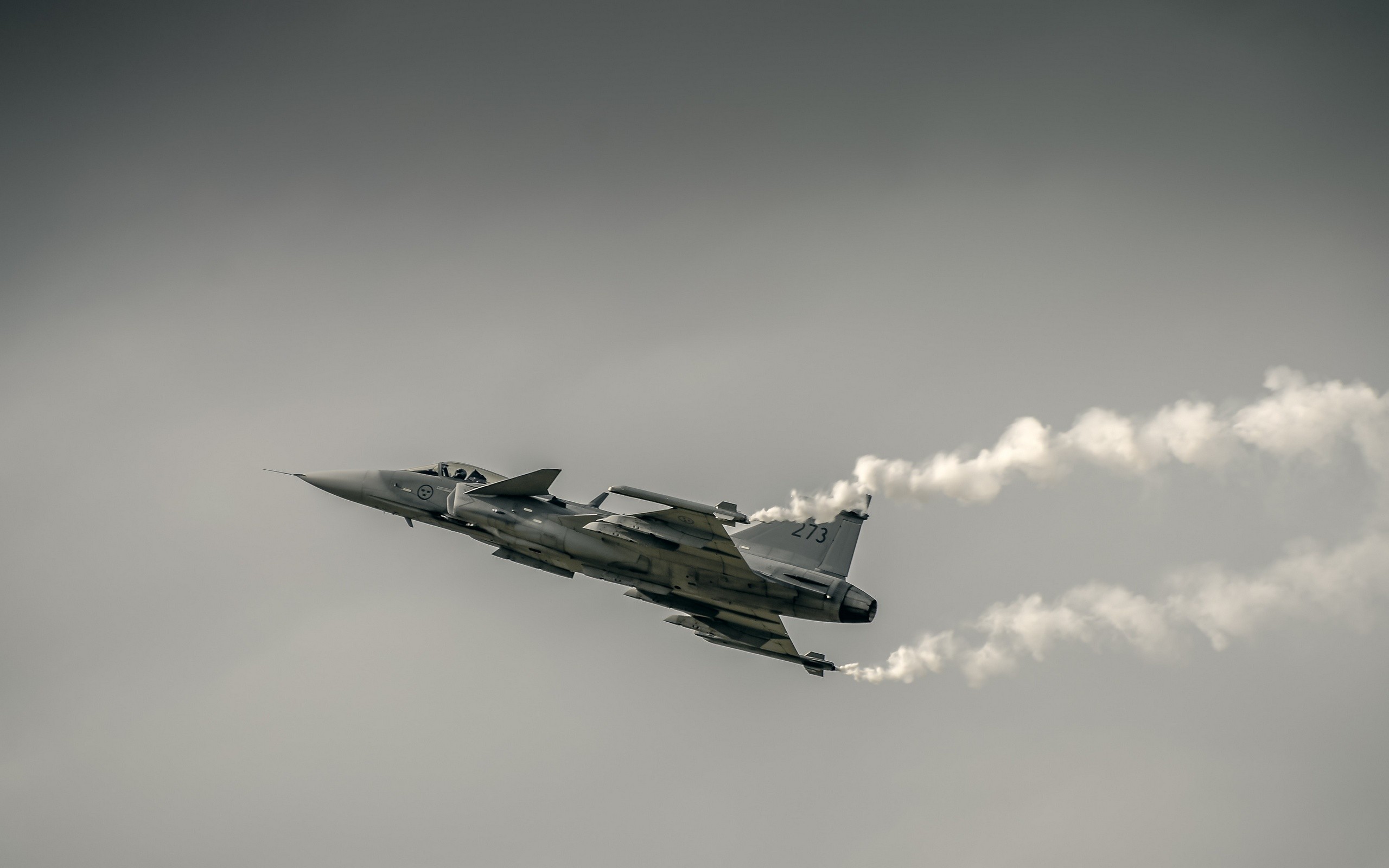 JAS-39 Gripen fighter jet flying with smoke trails HD Wallpaper