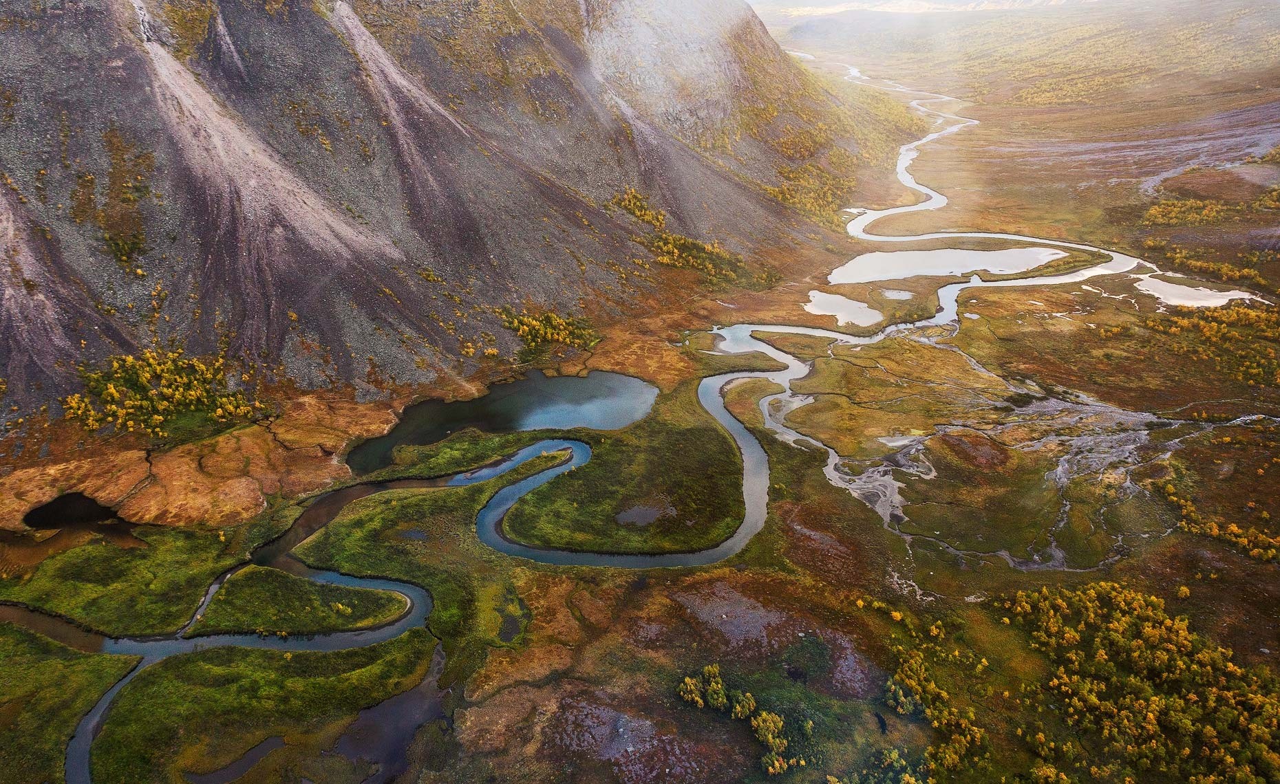 Aerial view of a winding river in a mountainous landscape in Sweden HD Wallpaper