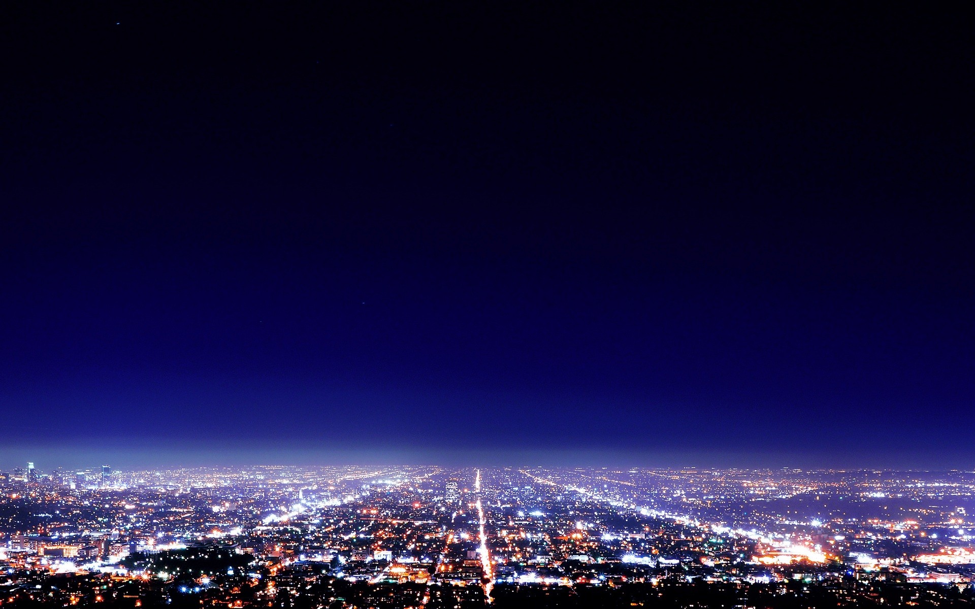 Cityscape at night with glowing lights HD Wallpaper