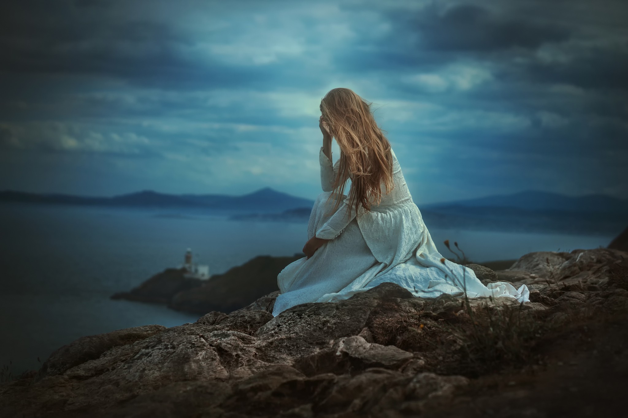Woman in white dress sitting on cliff overlooking the sea HD Wallpaper