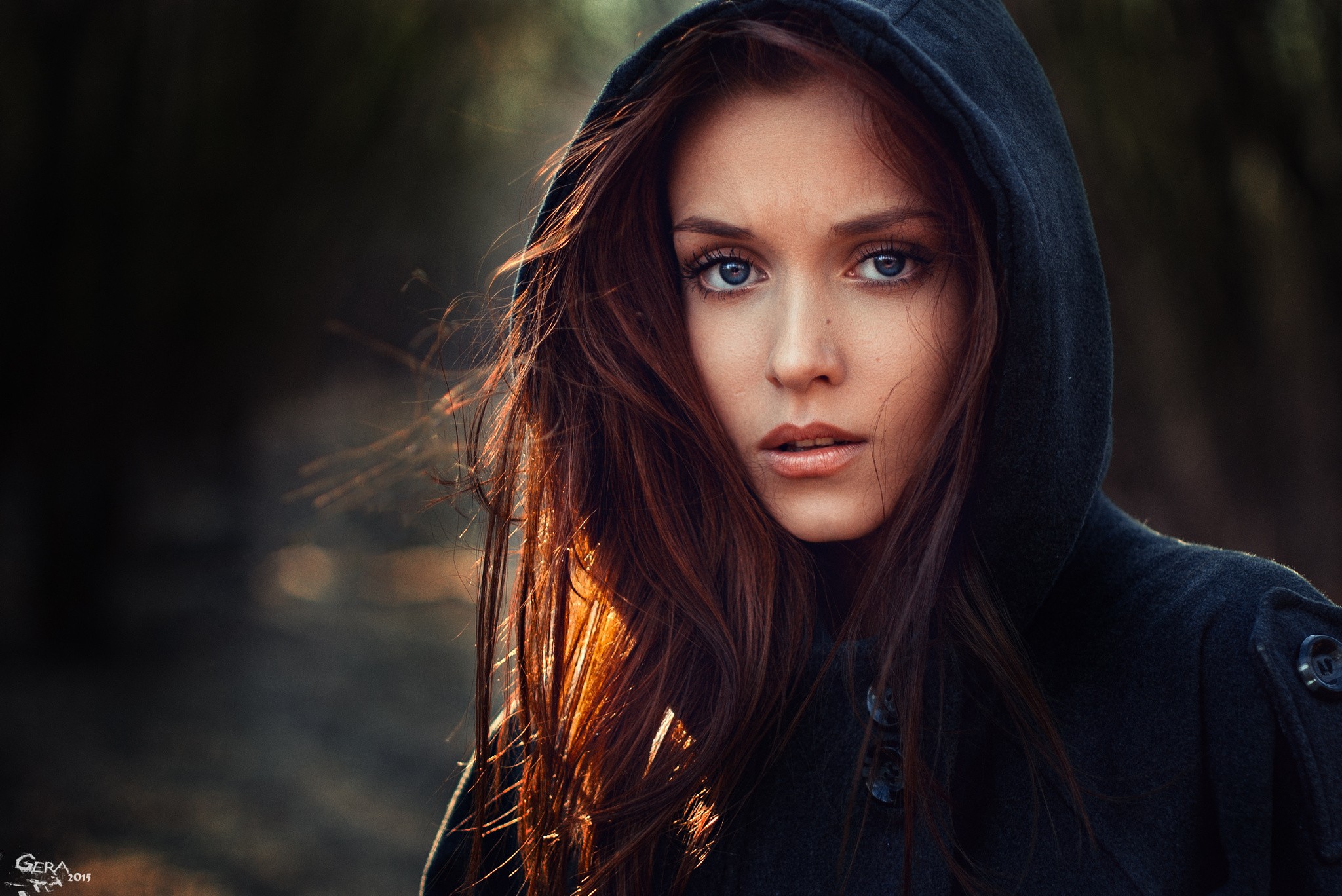 Woman with blue eyes wearing a black hood HD Wallpaper