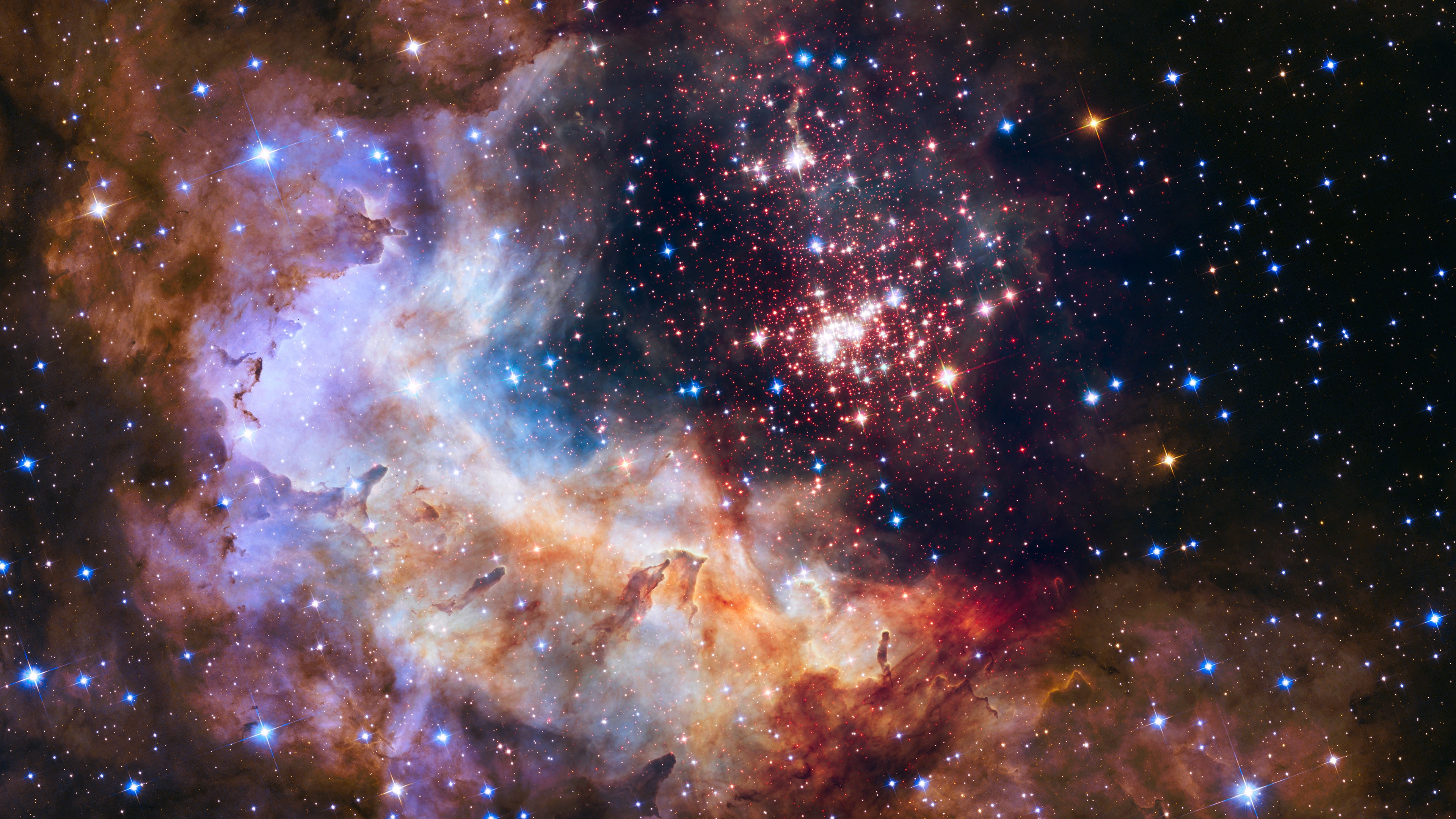 A colorful nebula filled with stars and cosmic dust HD Wallpaper