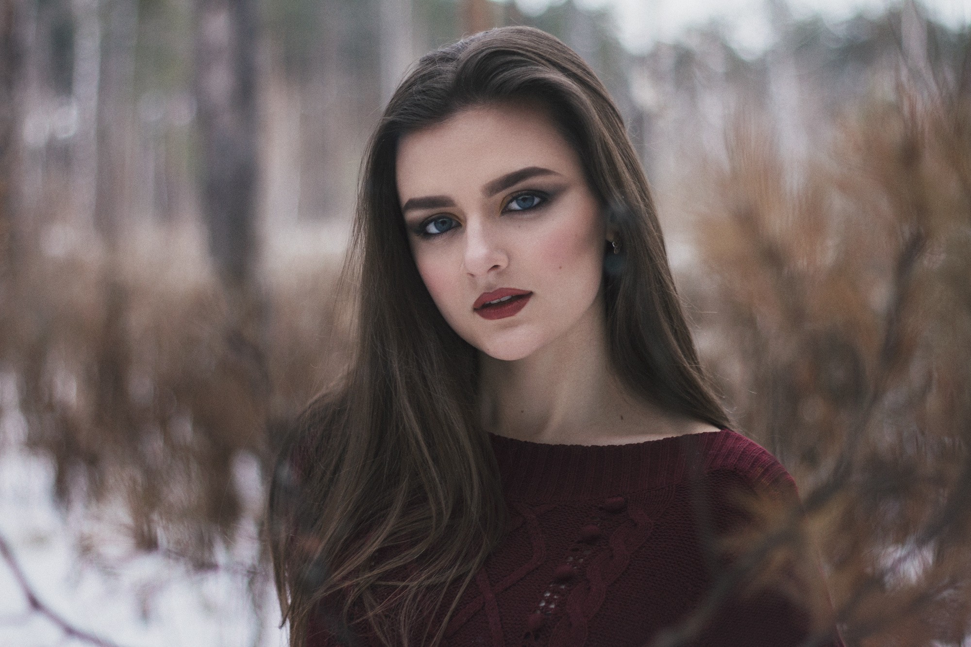 Woman with dark hair and makeup in a forest HD Wallpaper