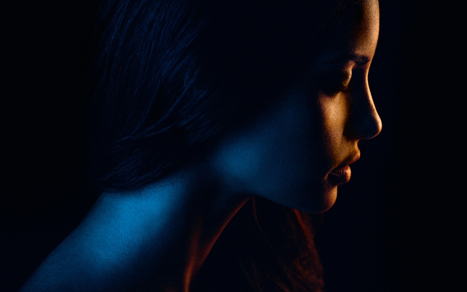 Woman's face illuminated by blue and orange lights HD Wallpaper