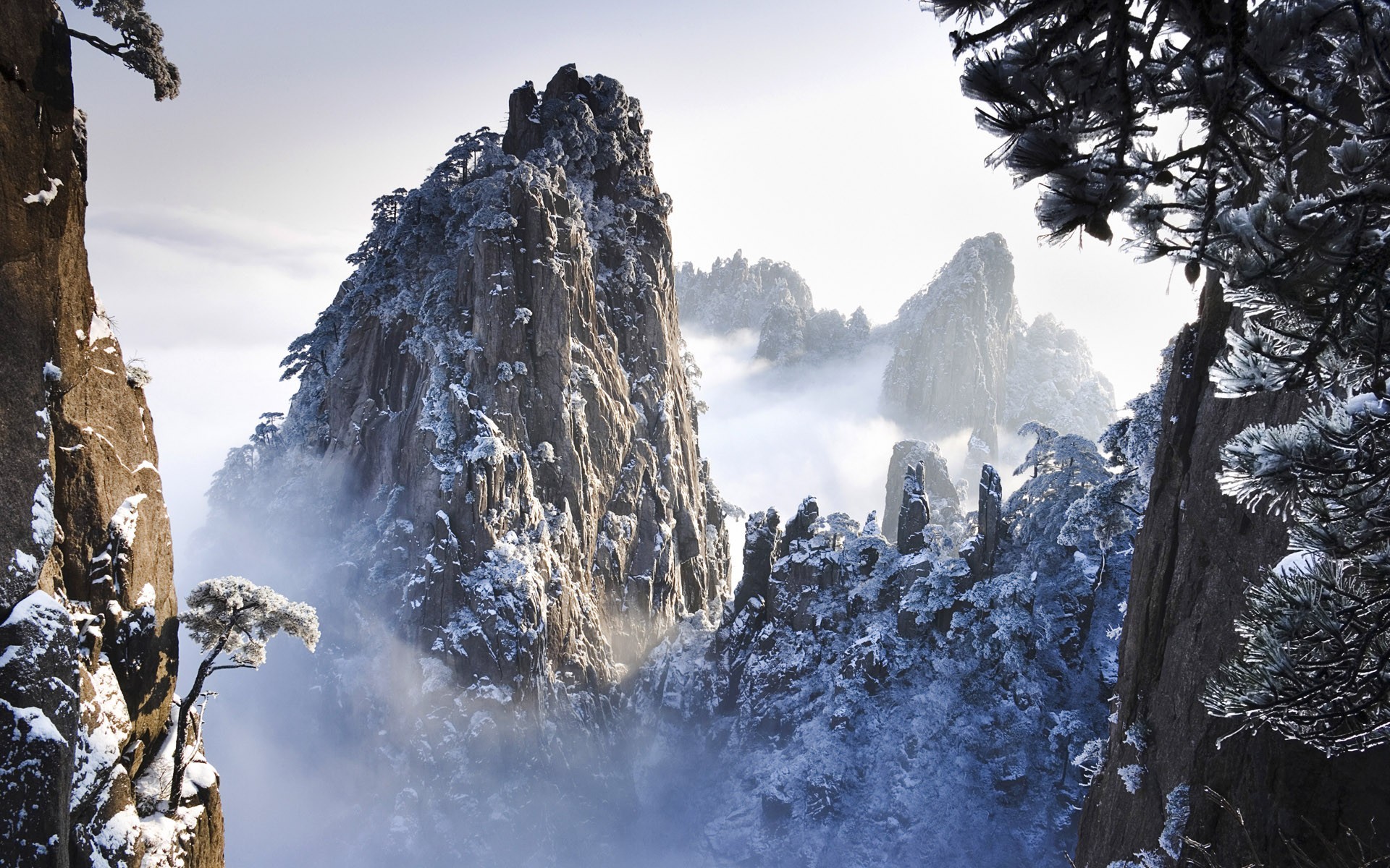 Snow-covered mountains shrouded in mist HD Wallpaper