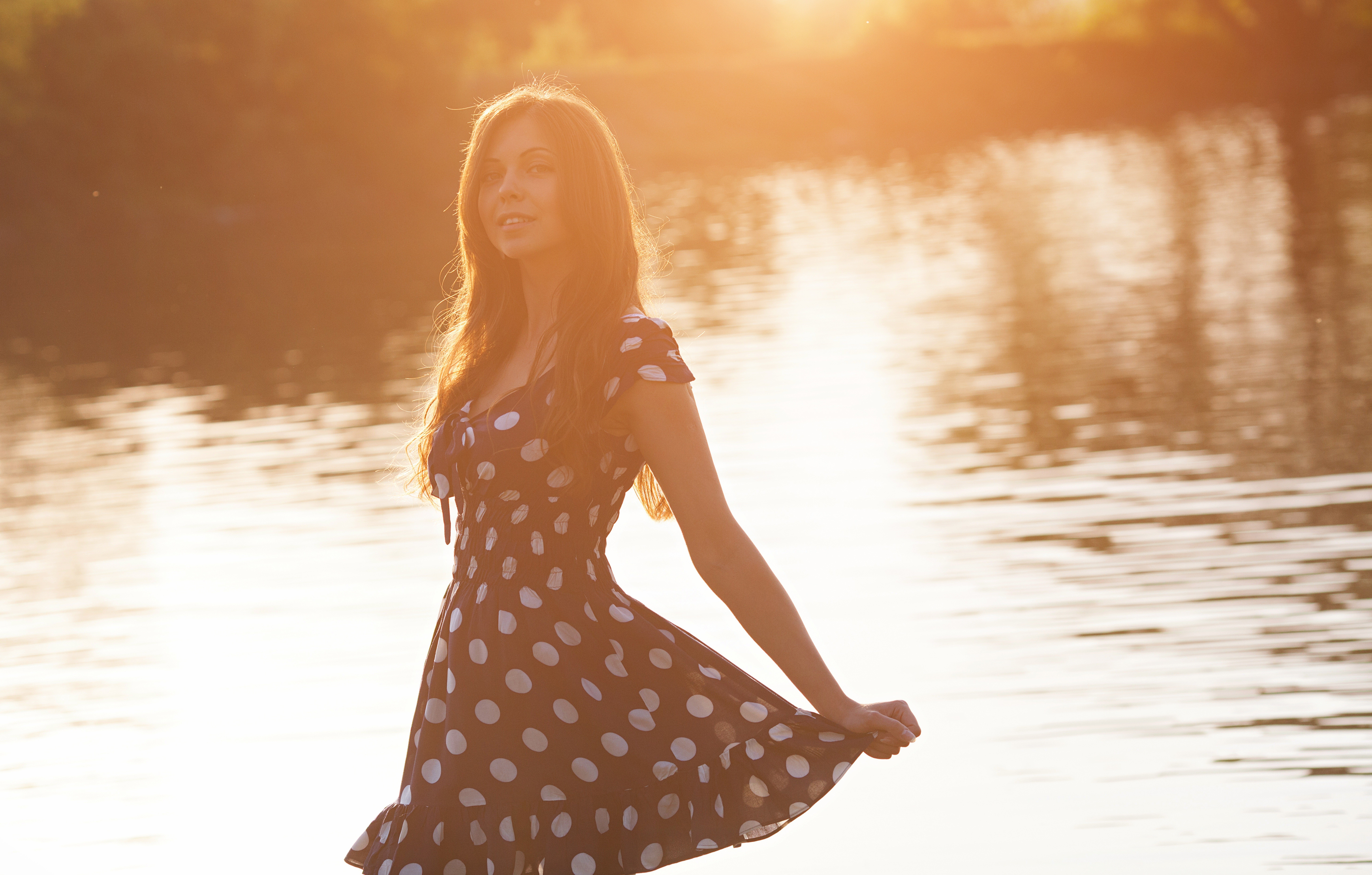 Woman in polka dot dress by the lake at sunset HD Wallpaper