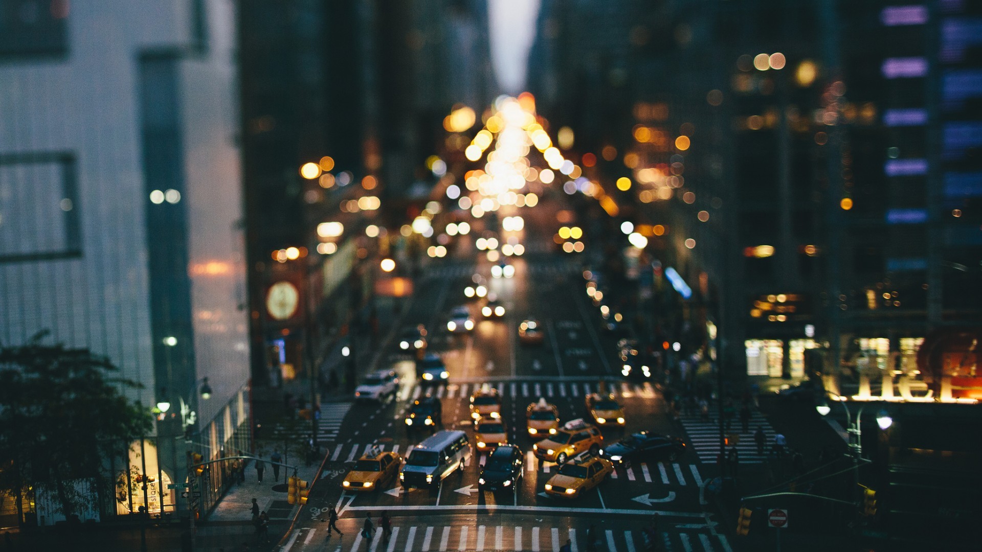 New York City street with traffic and buildings at night HD Wallpaper