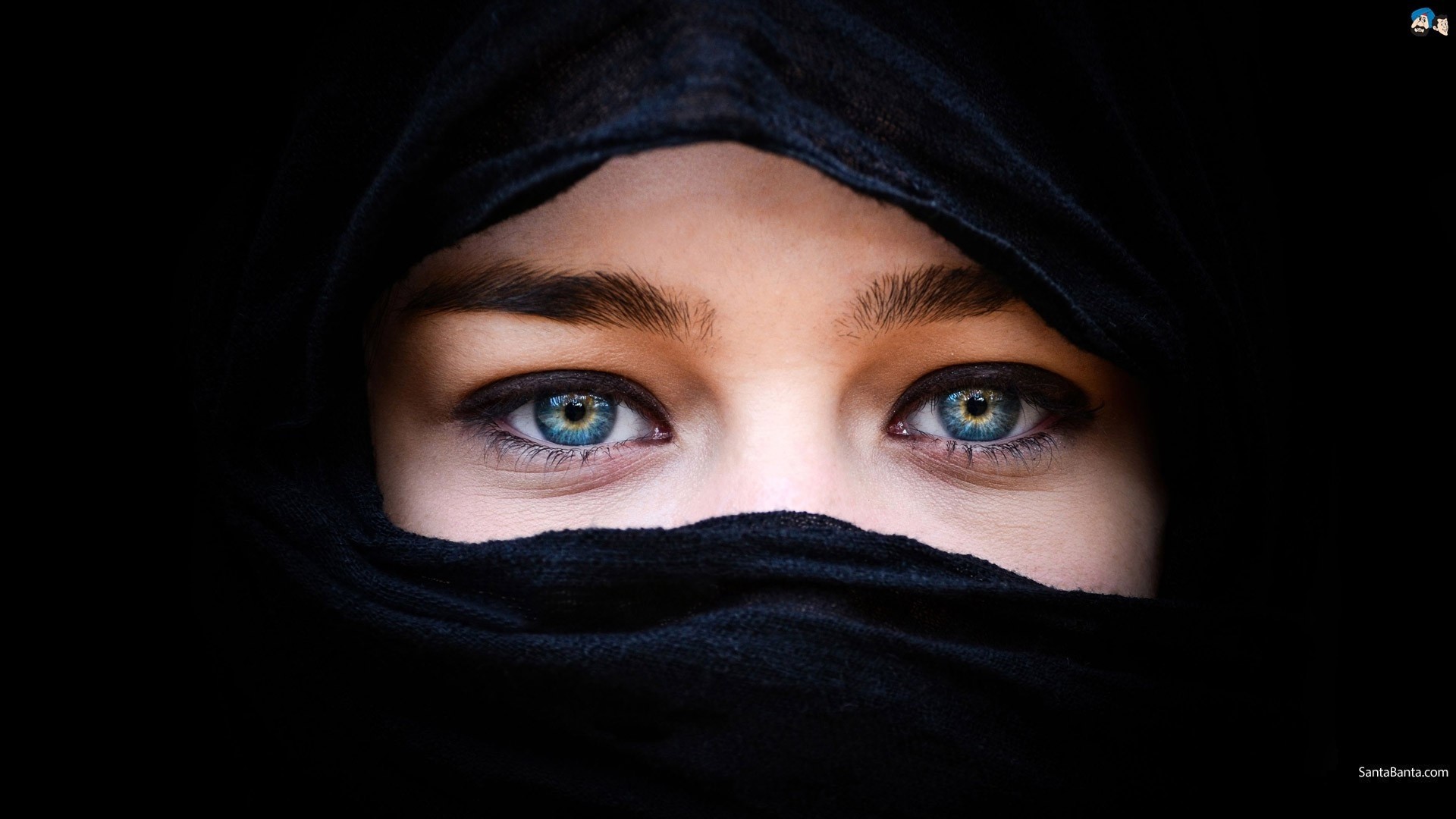 Close-up of blue eyes behind black fabric HD Wallpaper