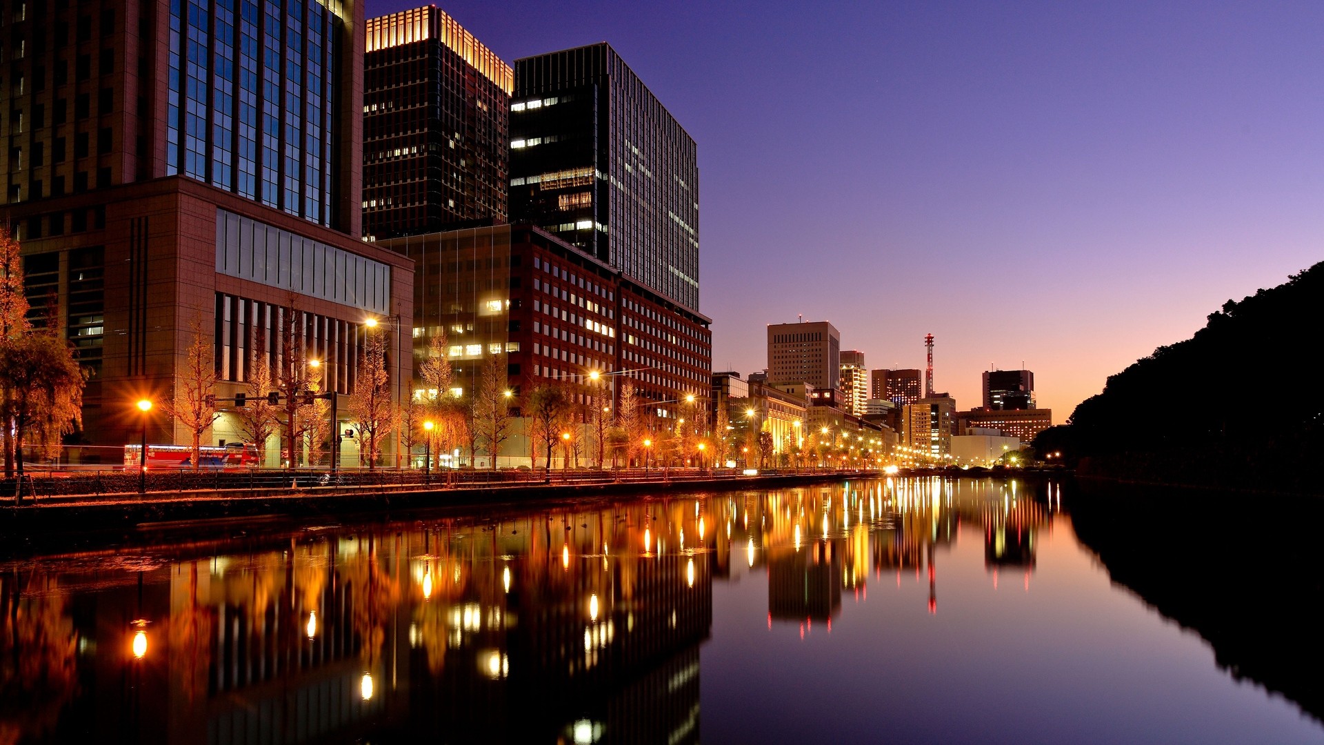 City skyline reflected in water at dusk HD Wallpaper