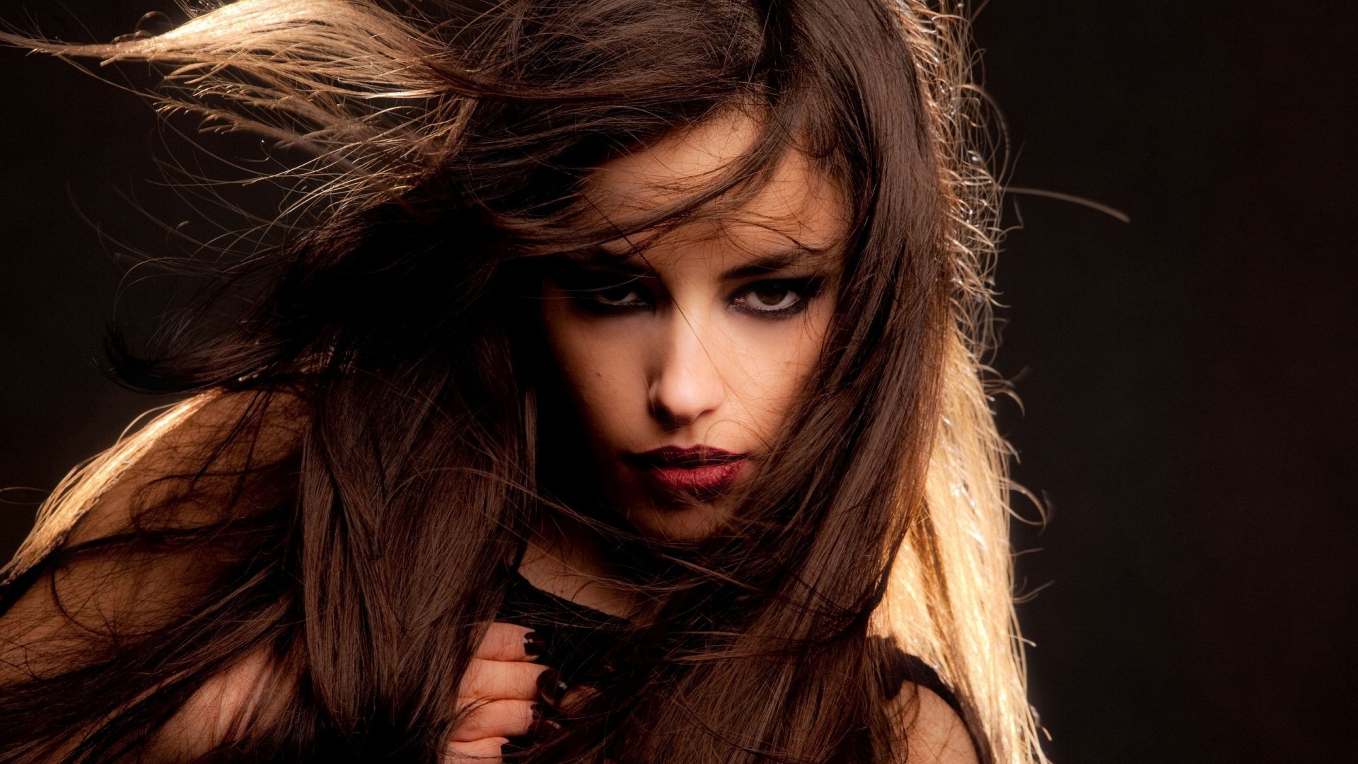 Woman with dark hair and dramatic makeup HD Wallpaper