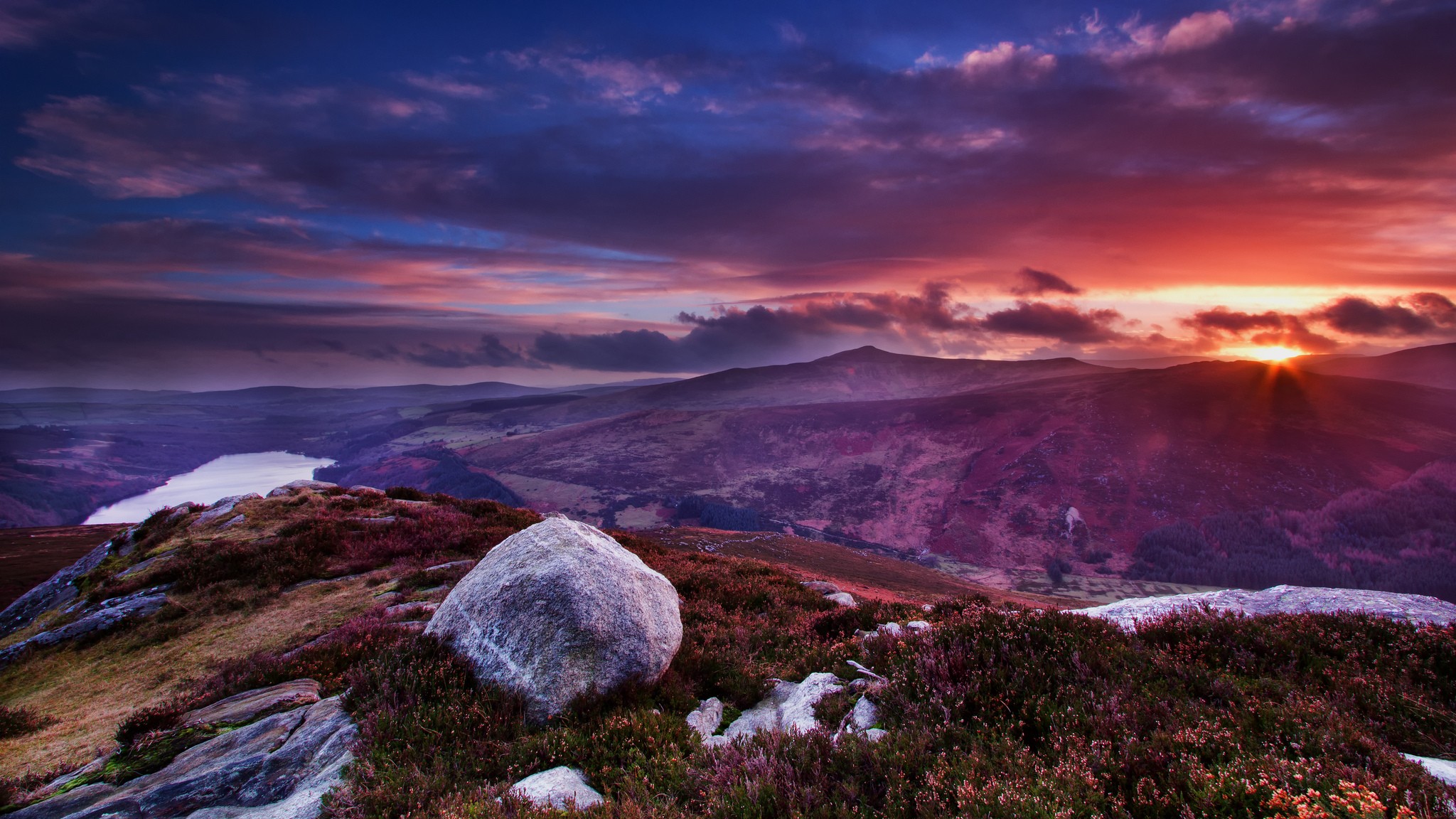 Sunset over a mountainous landscape with a lake HD Wallpaper