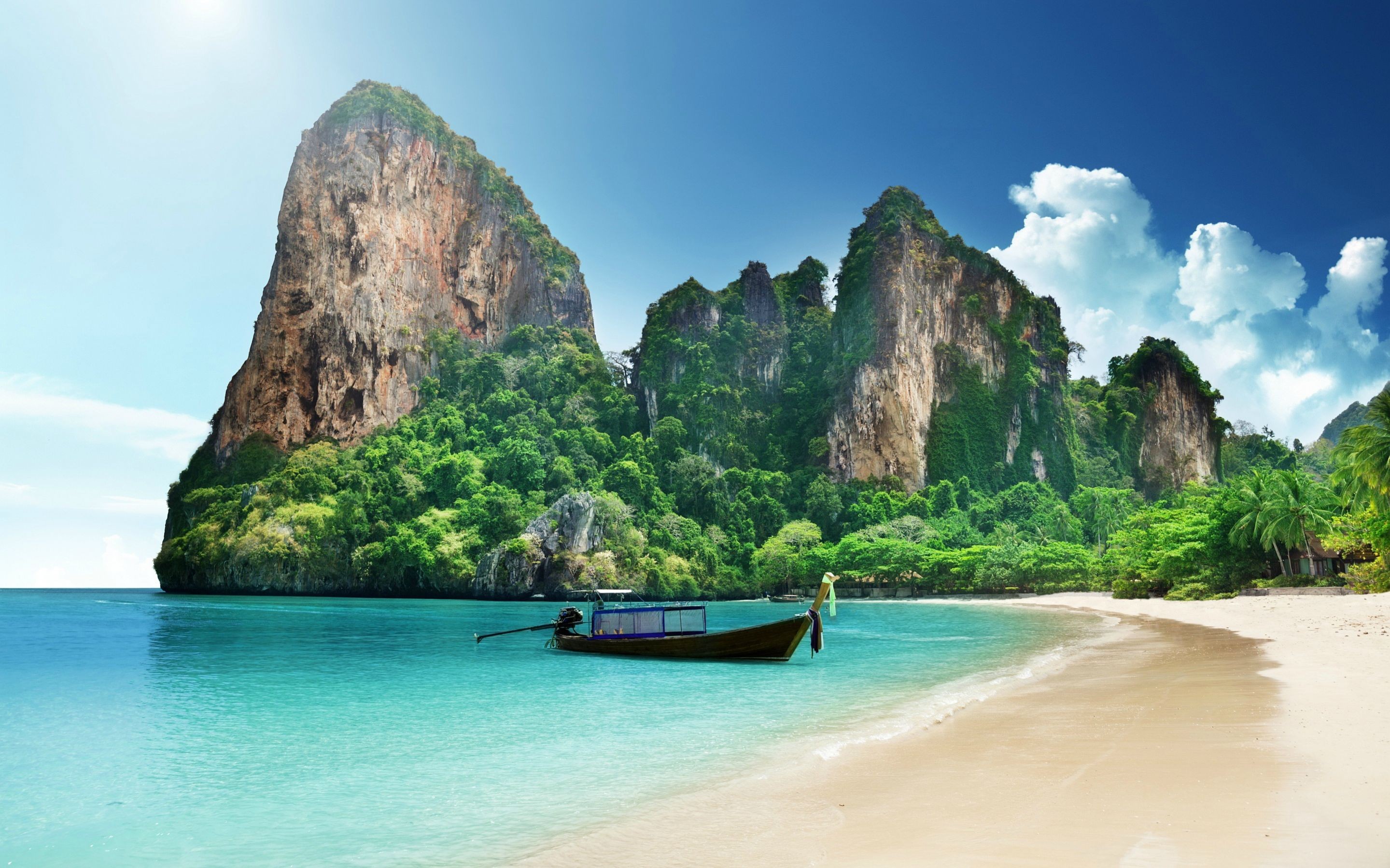 Boat on a tropical beach with limestone cliffs HD Wallpaper