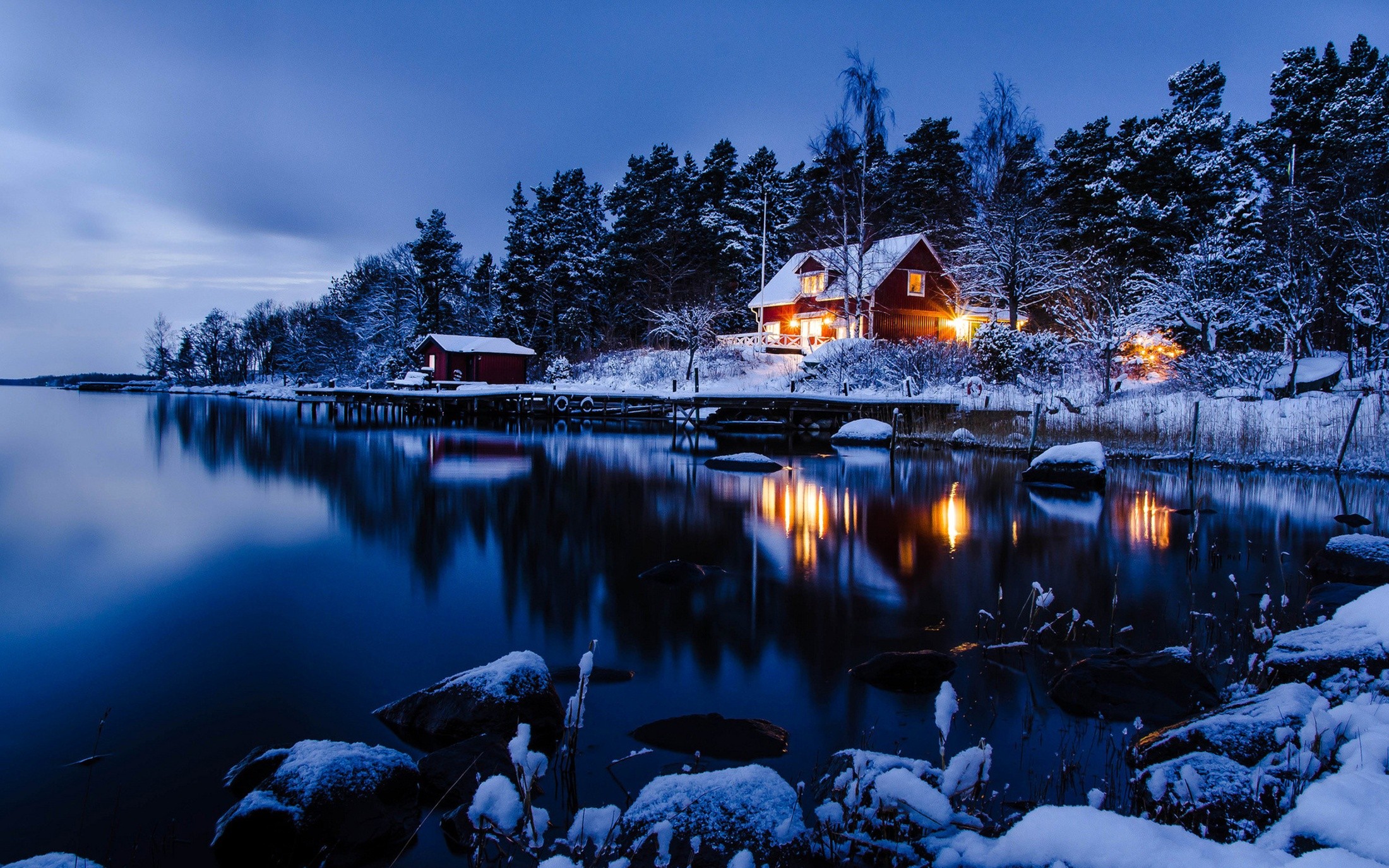 Winter cabin by a lake at dusk HD Wallpaper