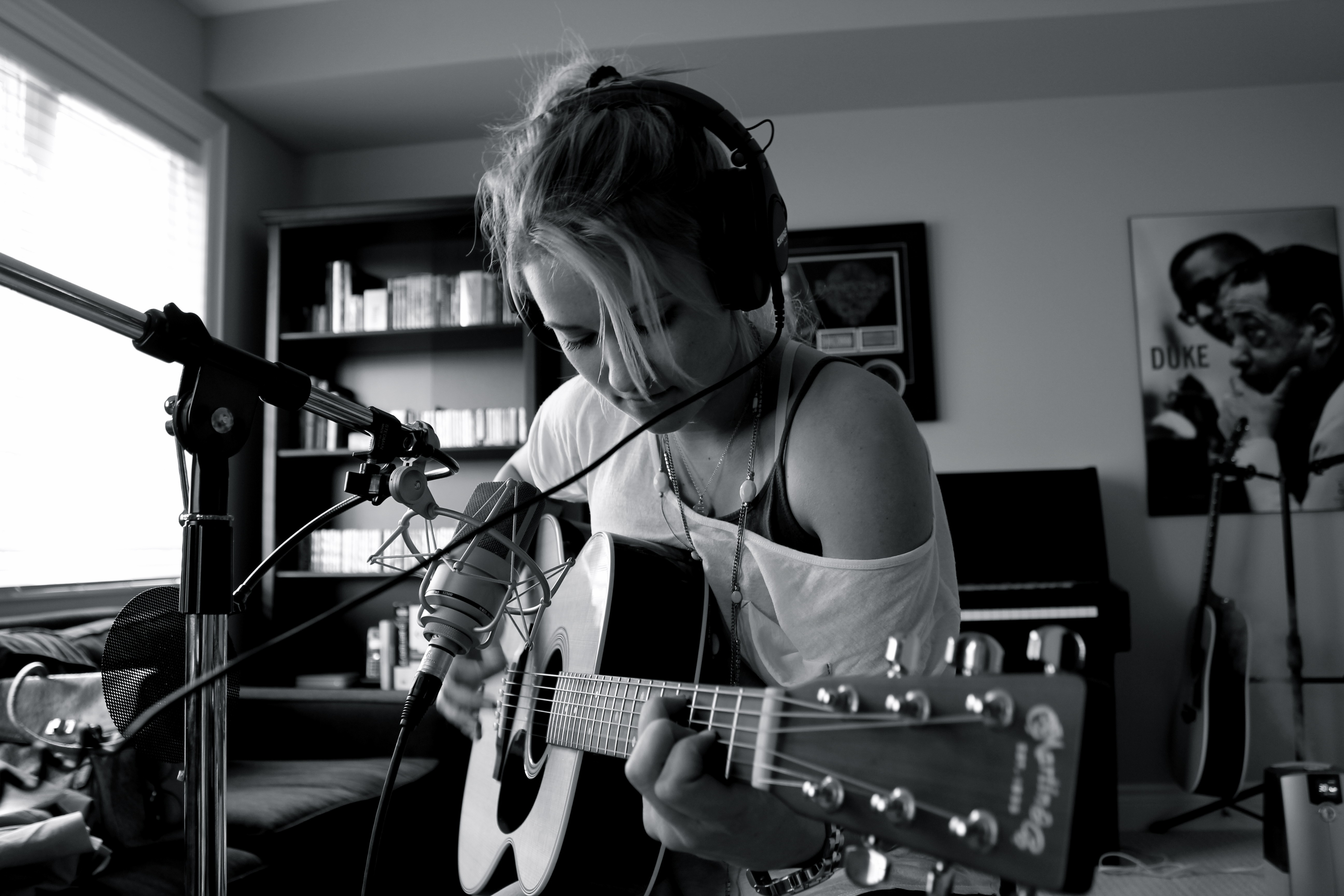 Emily Osment playing guitar with headphones HD Wallpaper