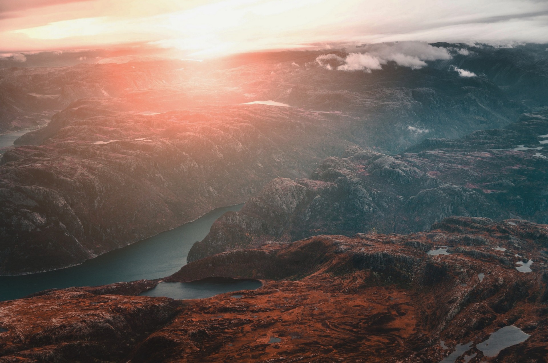 Aerial view of mountains and a fjord at sunset HD Wallpaper