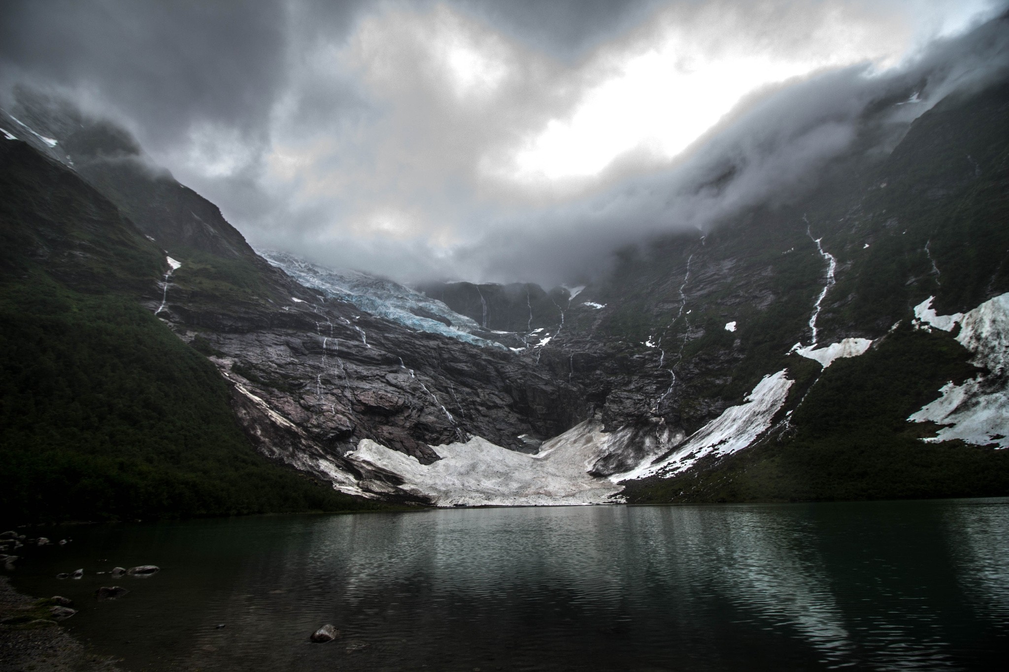 Glacier and lake in Norway under dark clouds HD Wallpaper