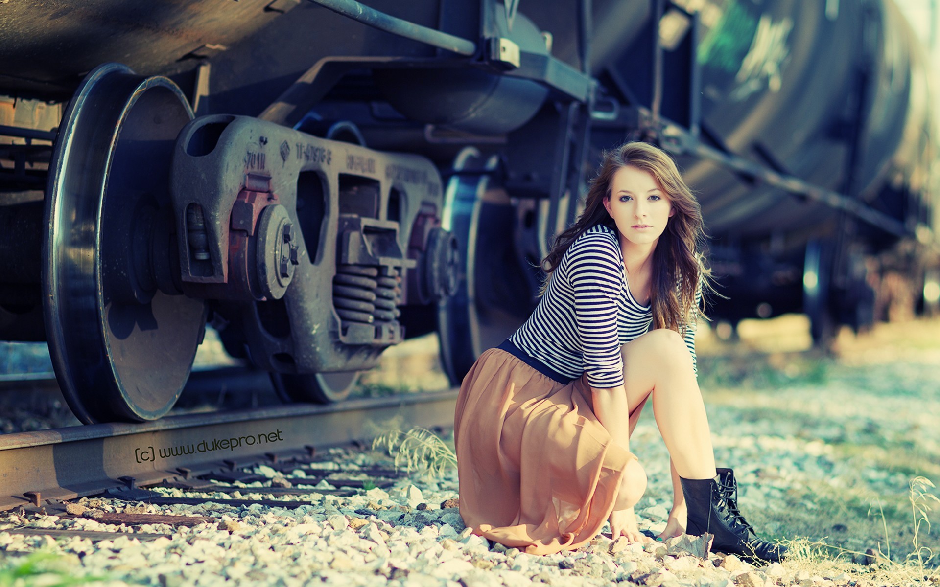 Woman posing by a train on railway tracks HD Wallpaper