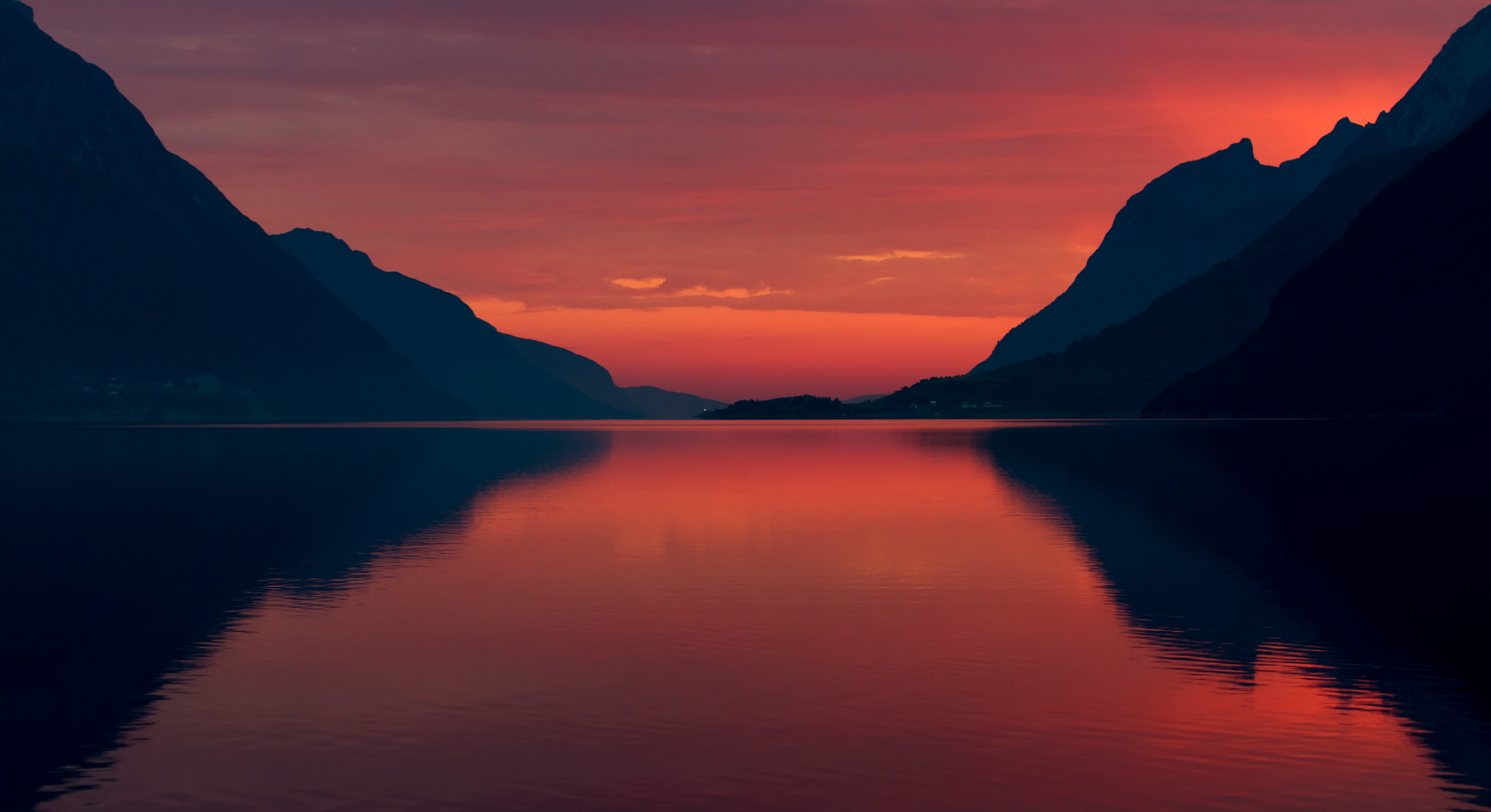 Sunset over a calm lake between mountains HD Wallpaper