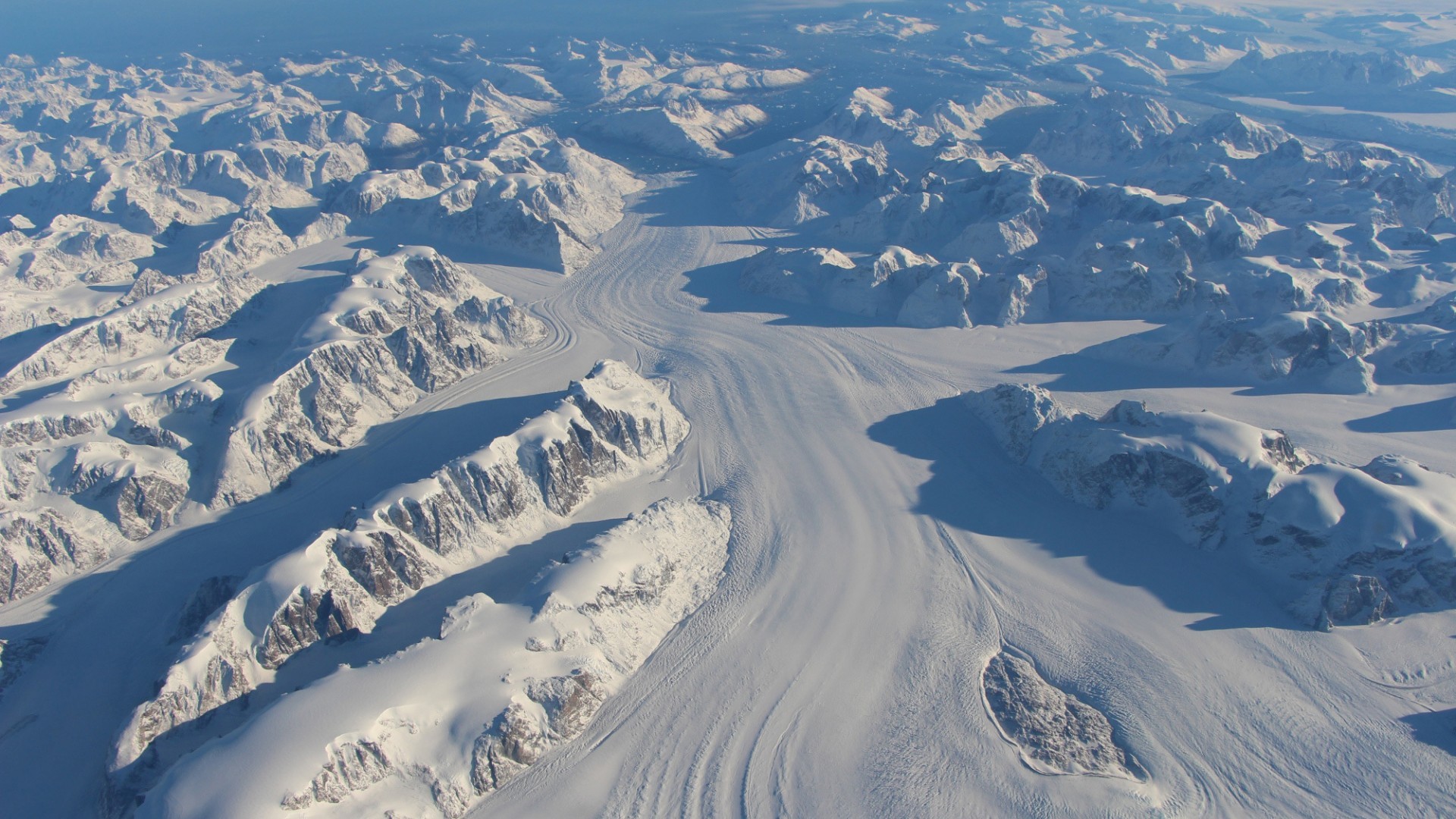 Aerial view of snow-covered mountains and glaciers in Greenland HD Wallpaper