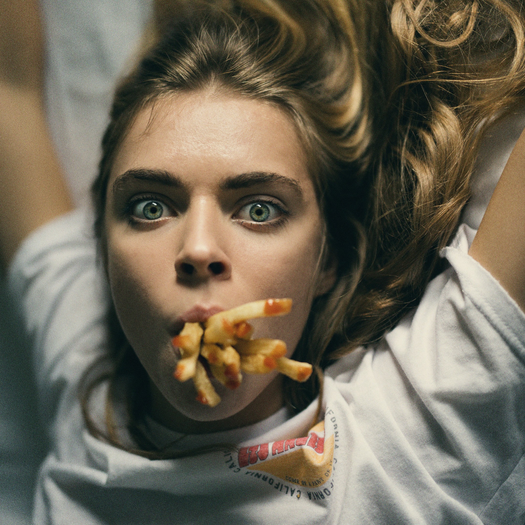 Woman with French Fries in Her Mouth HD Wallpaper