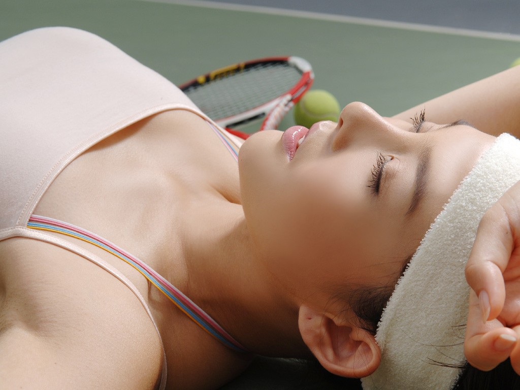 Asian woman lying on tennis court with racket and balls HD Wallpaper