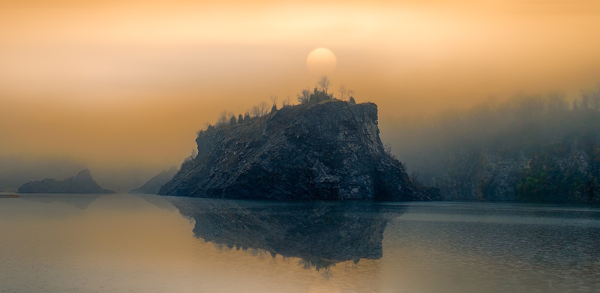 Misty lake with rocky island and sun reflection HD Wallpaper