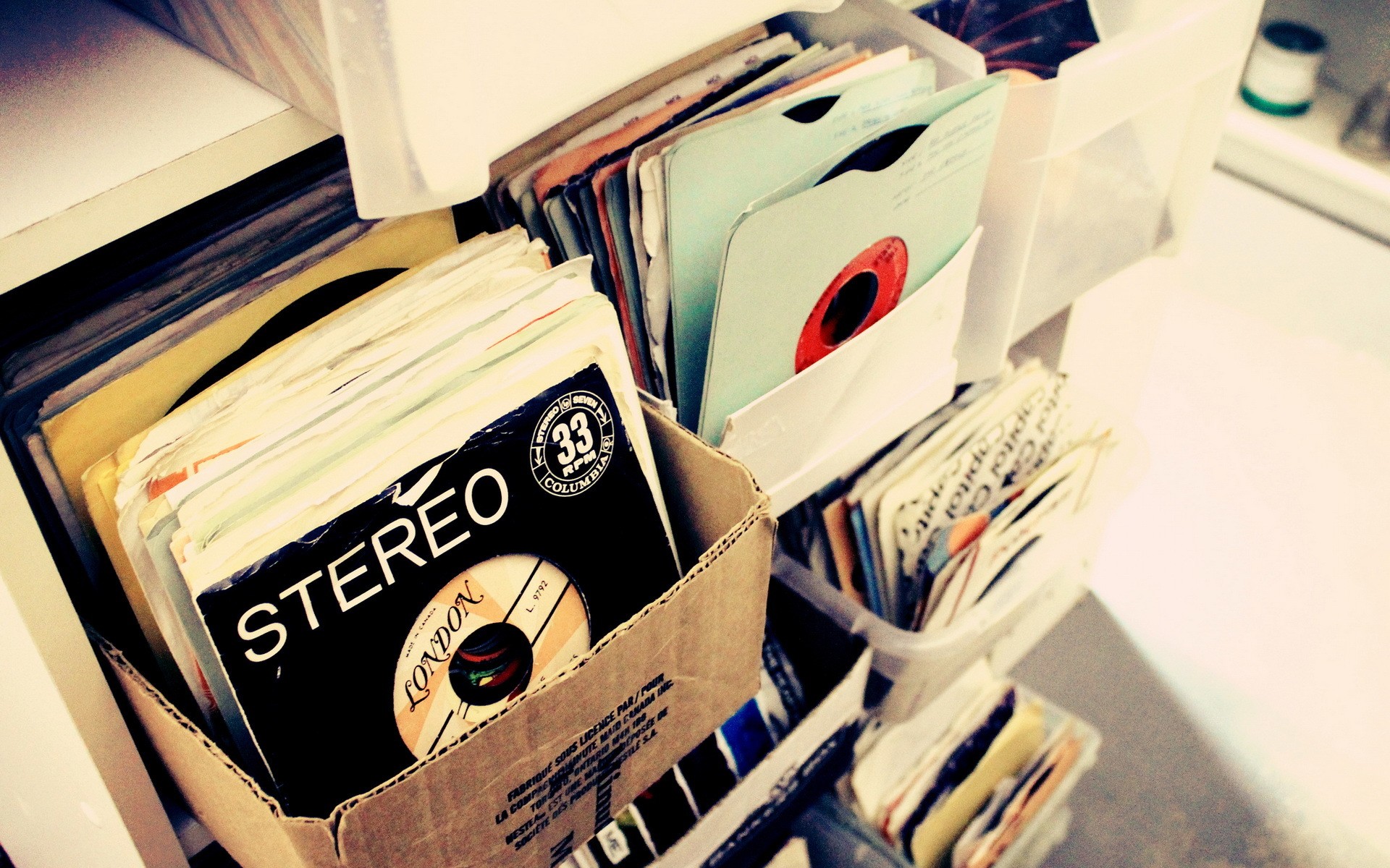 Stack of vinyl records in storage boxes HD Wallpaper