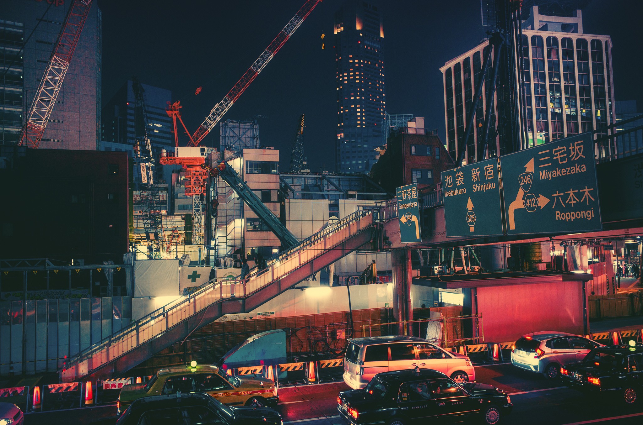 Nighttime Cityscape with Cranes and Traffic in Japan HD Wallpaper