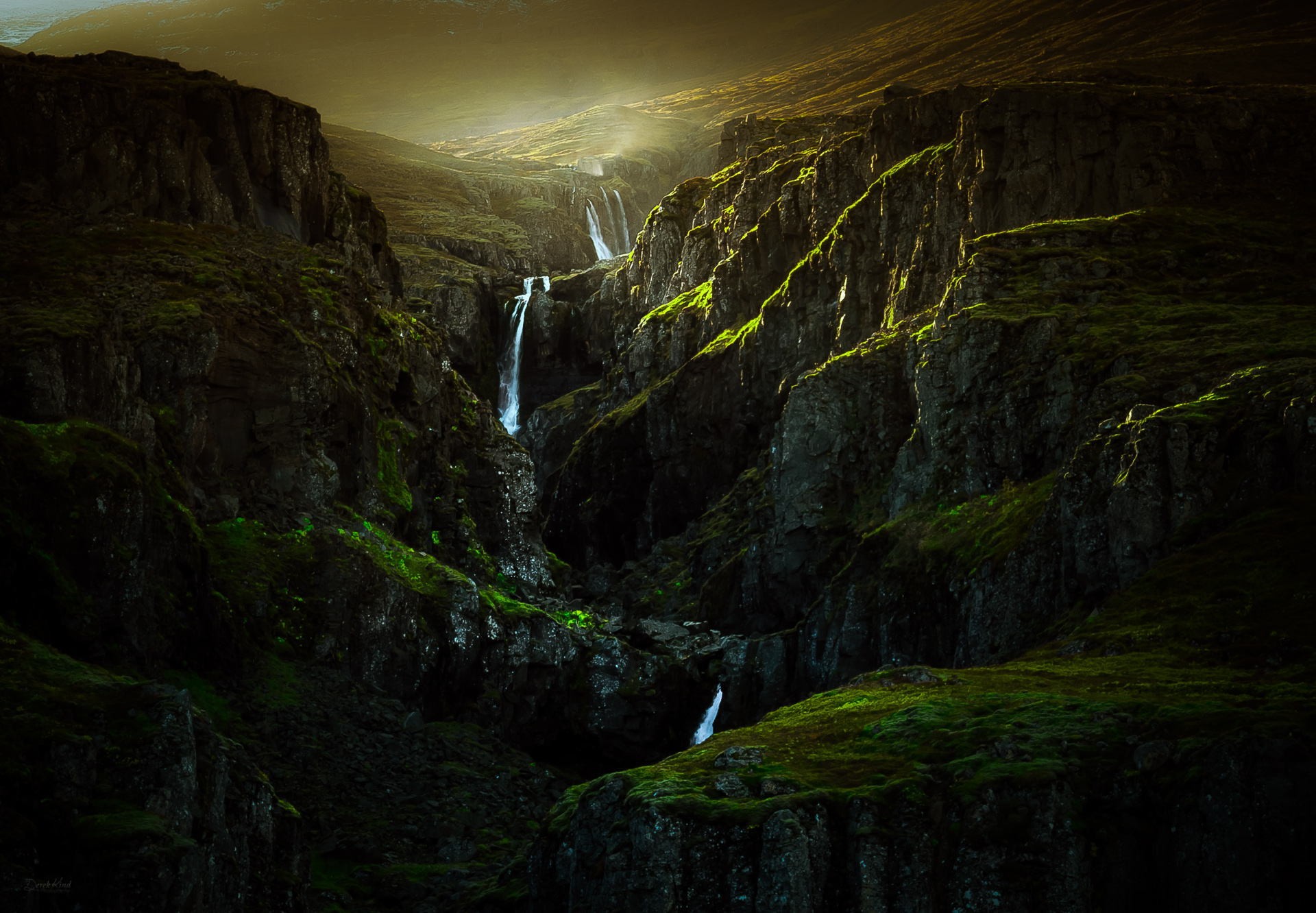 Dramatic waterfall cascading through a mossy canyon HD Wallpaper