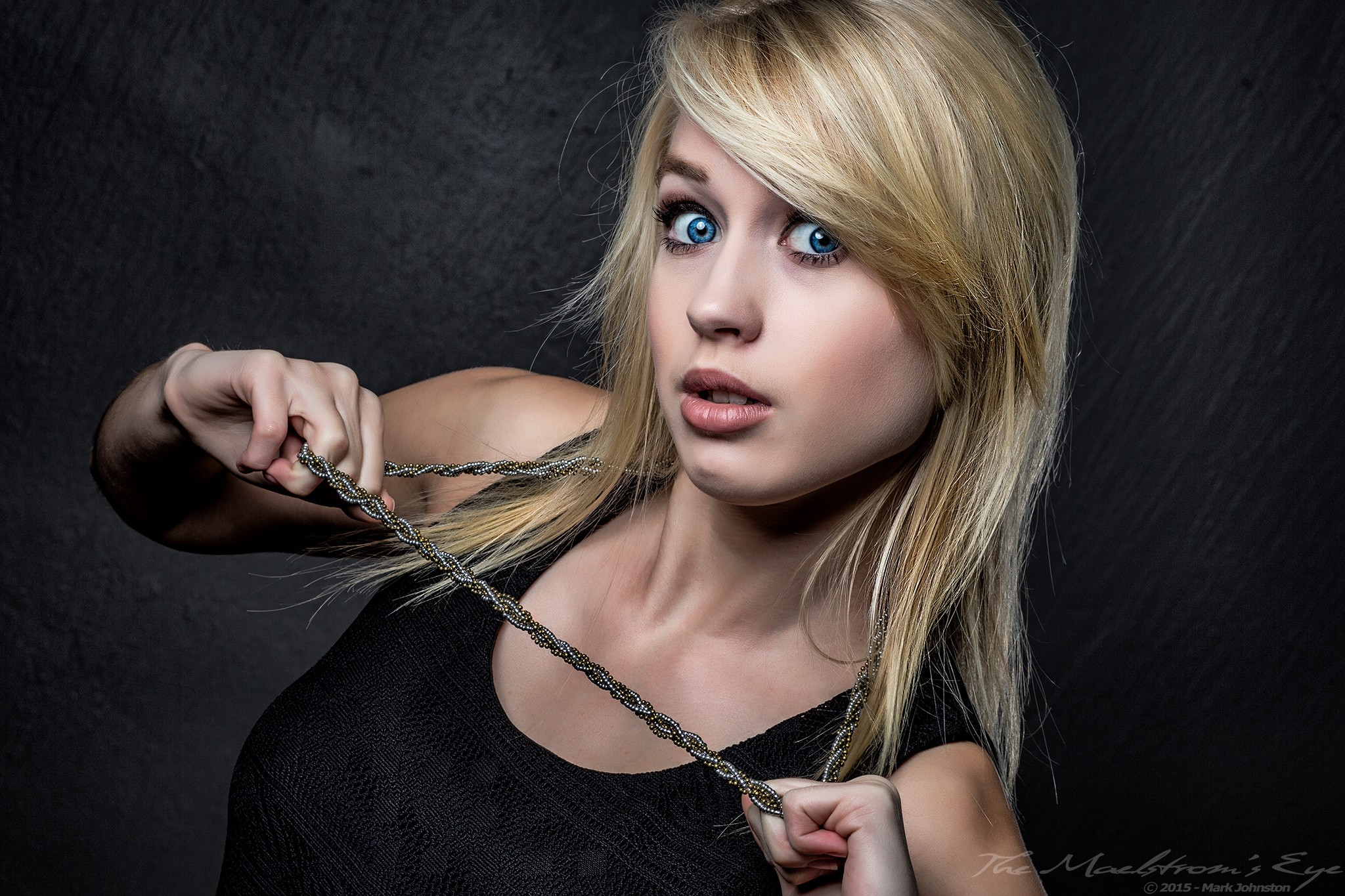 Woman with blonde hair and blue eyes holding a necklace HD Wallpaper