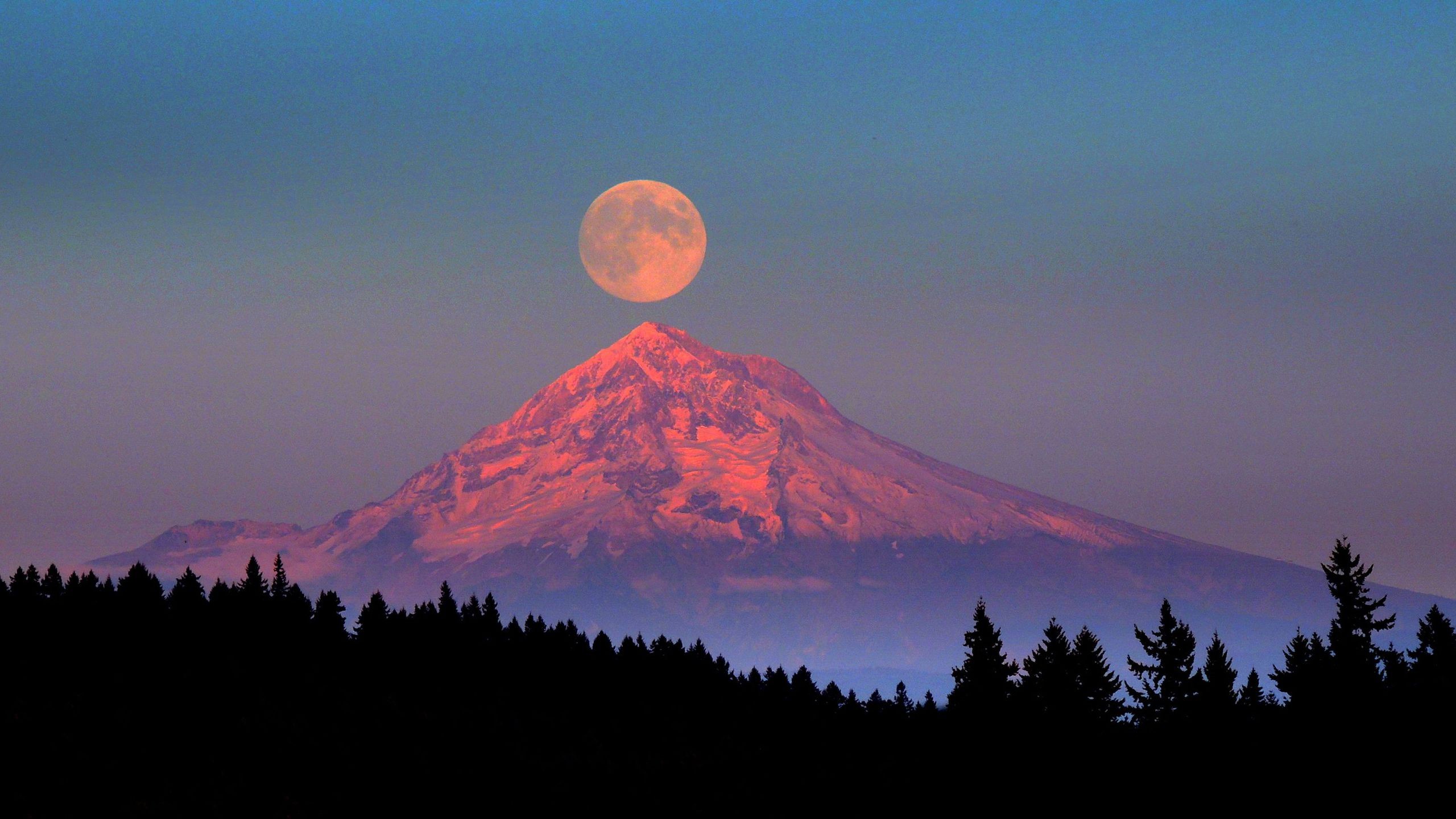 Full moon over a snow-capped mountain at sunset HD Wallpaper