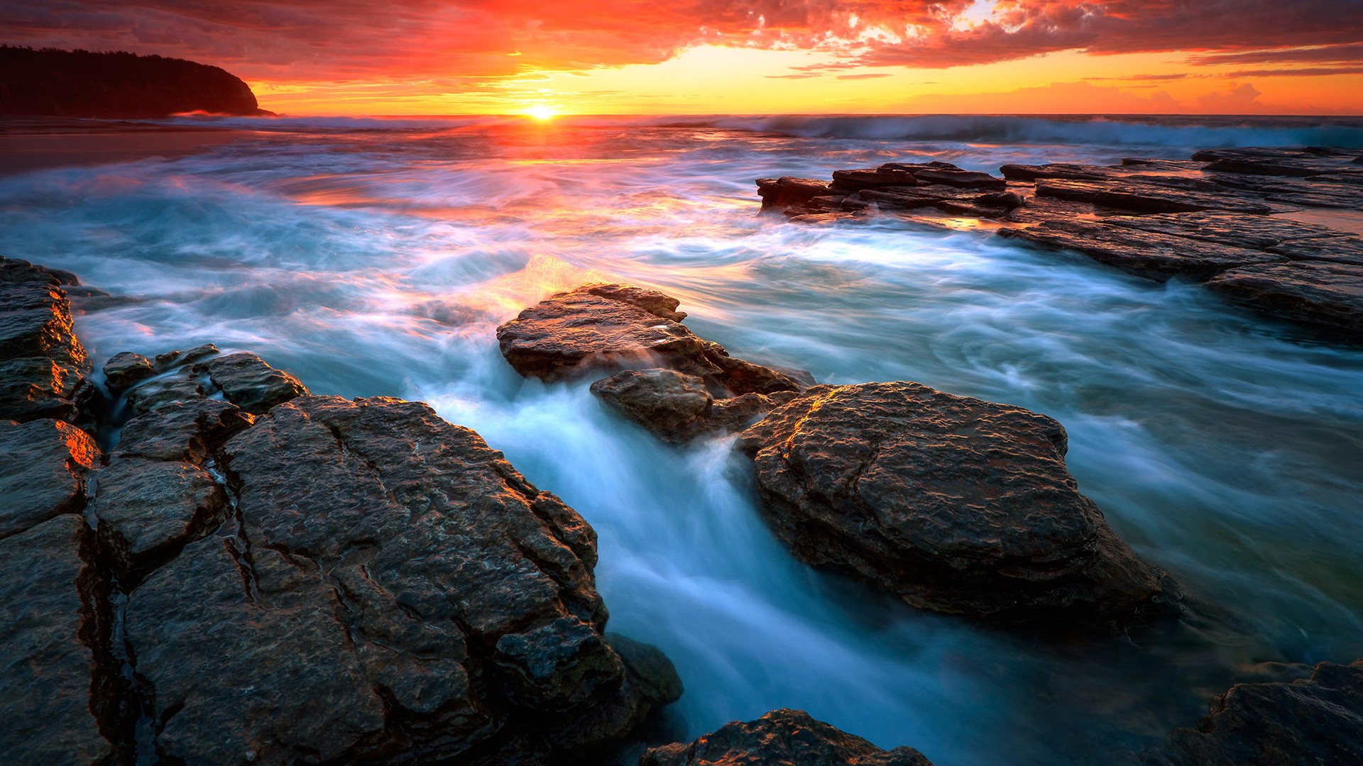 Sunset over the rocky coast with ocean waves HD Wallpaper