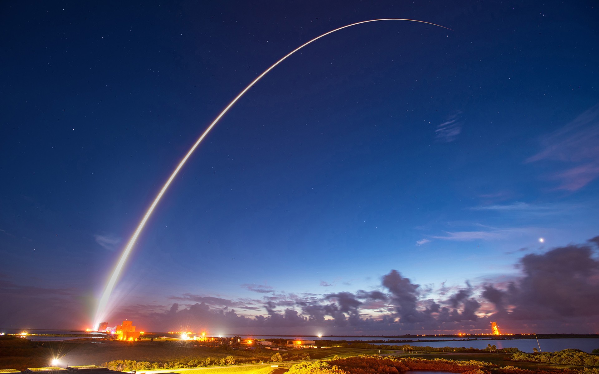 Rocket Launch Trail Over Coastal Landscape at Night HD Wallpaper