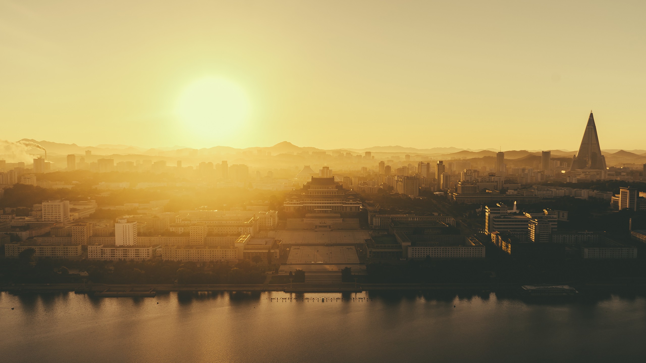 Pyongyang cityscape at sunrise with the Ryugyong Hotel HD Wallpaper