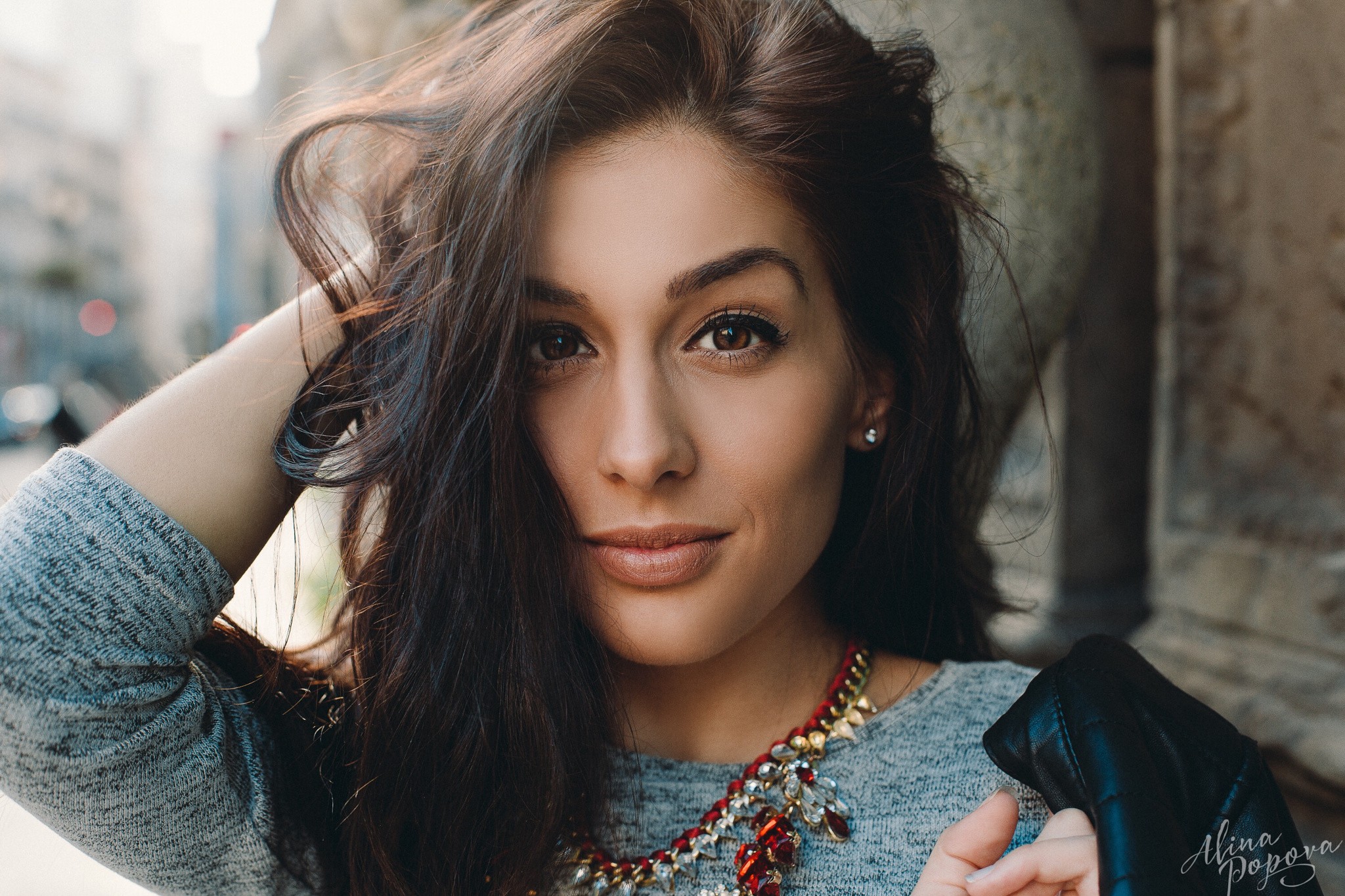 Portrait of a woman with dark hair and a necklace HD Wallpaper